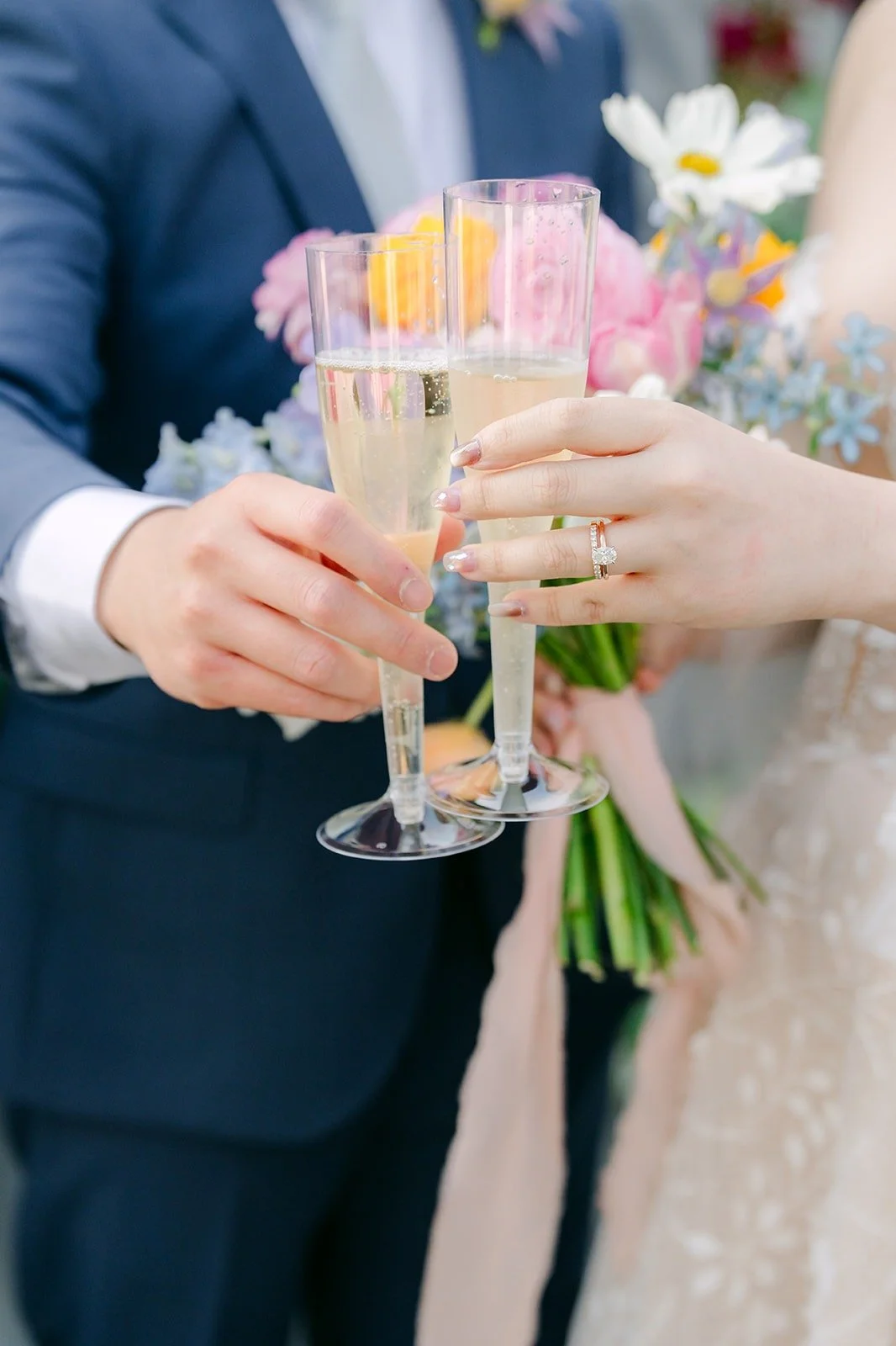 Joanna and Jerrick toasting with champagne flutes