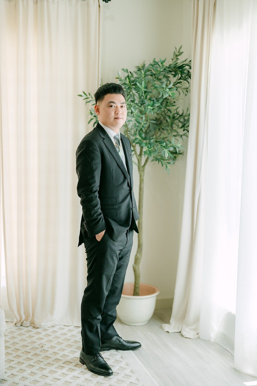 Vincent in his black suit in the Airbnb living room