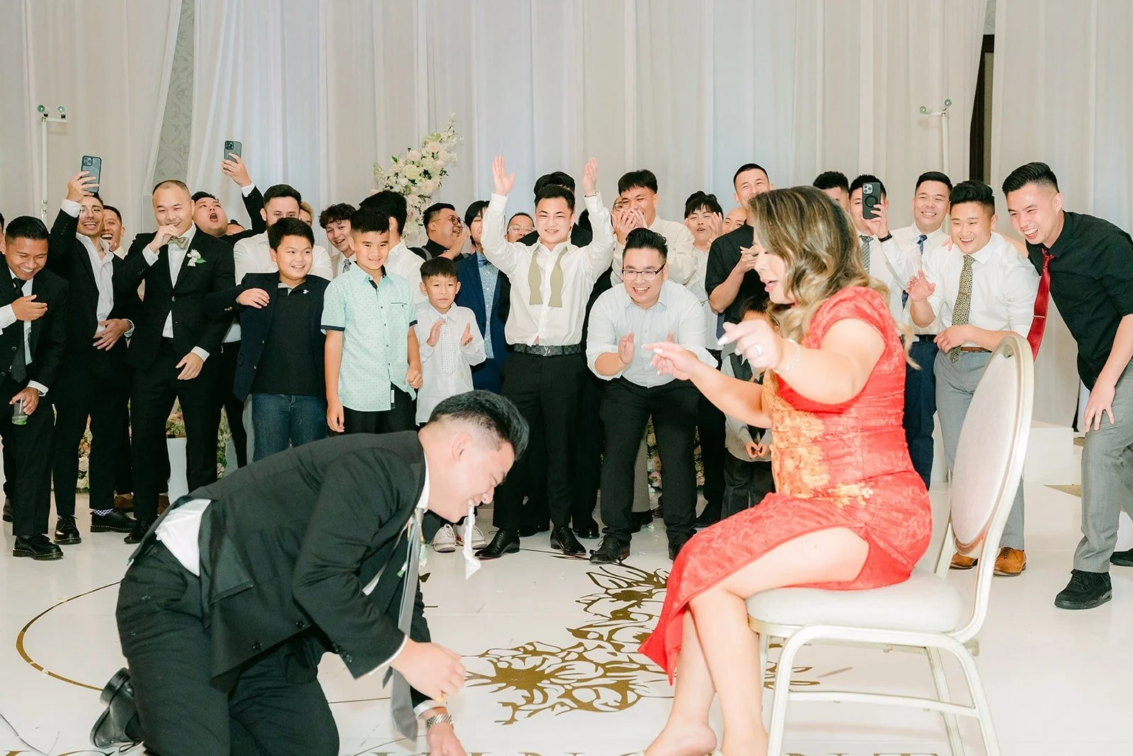 Vincent removing the garter as the groomsmen cheer