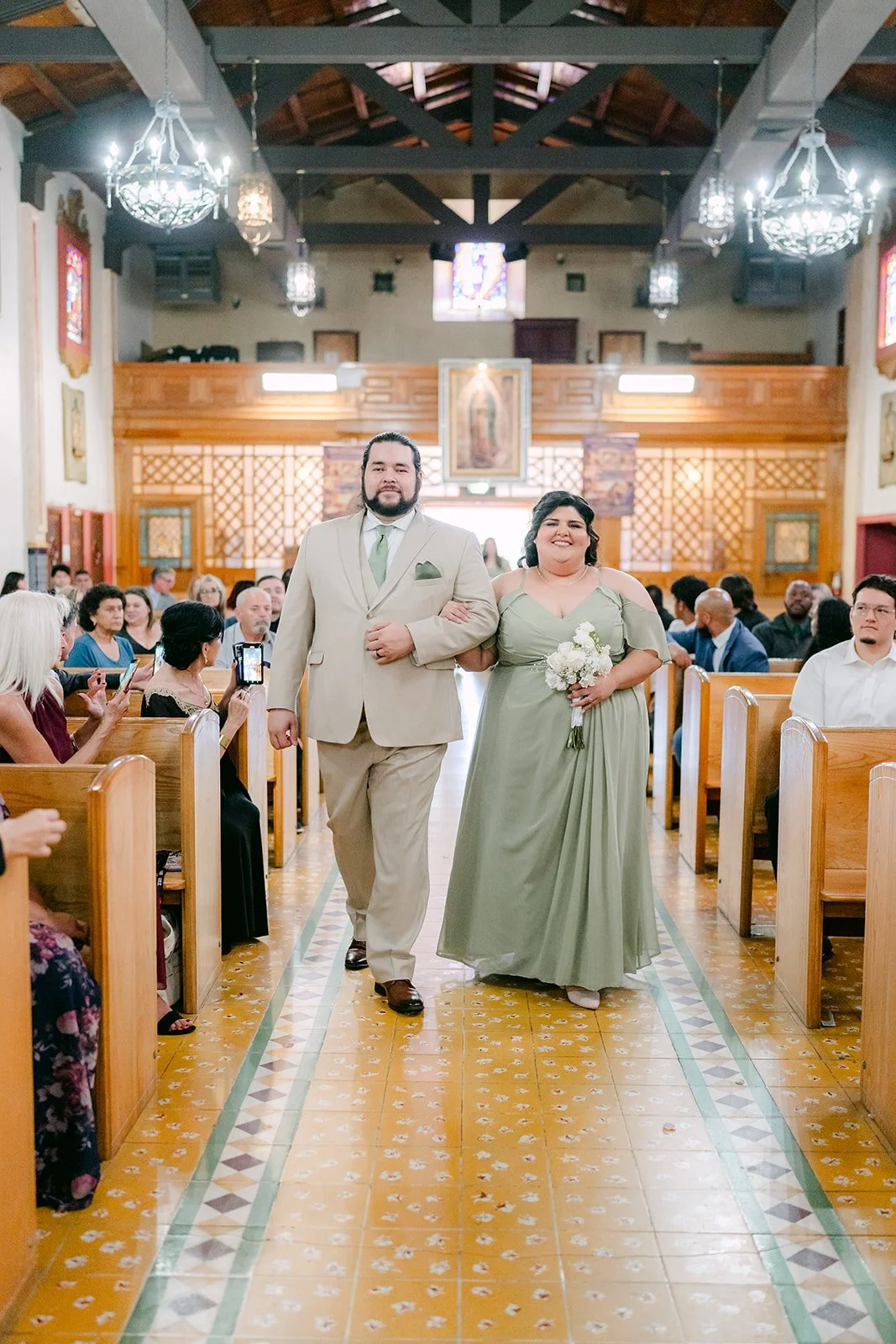 A groomsman and bridesmaid walking down the aisle.