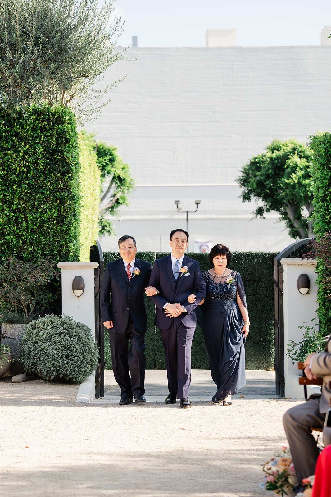 Lawrence walking into the ceremony with his parents