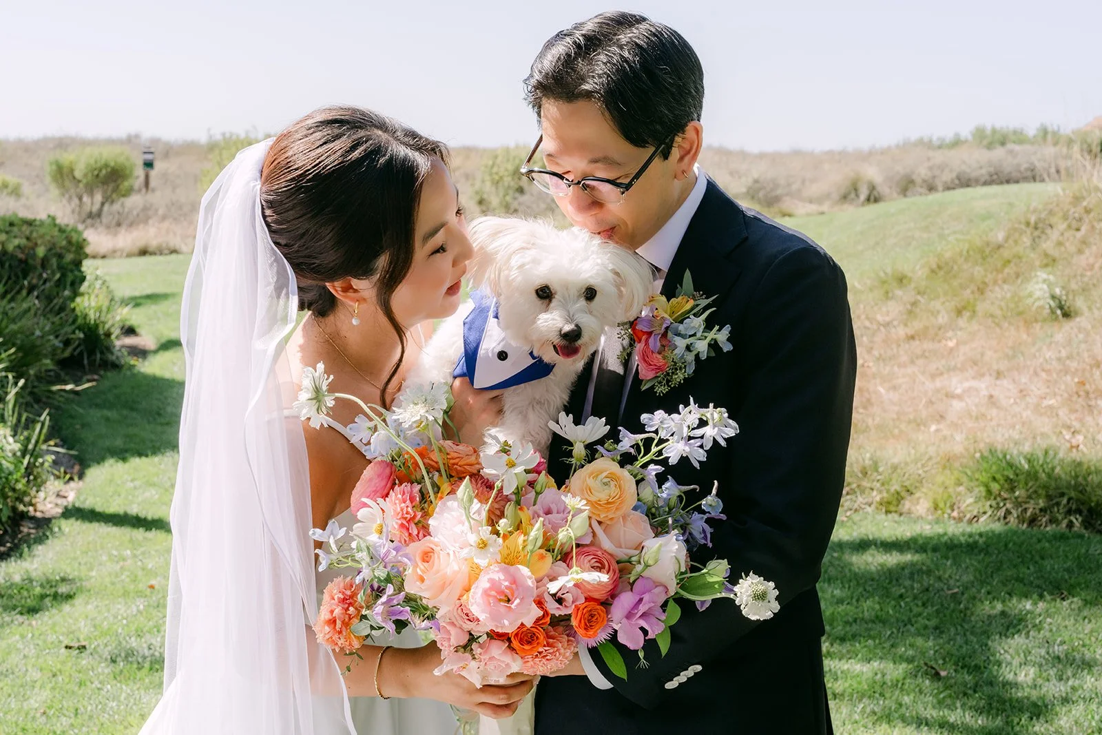 Saya and Leroy with their pup against the coastal hills