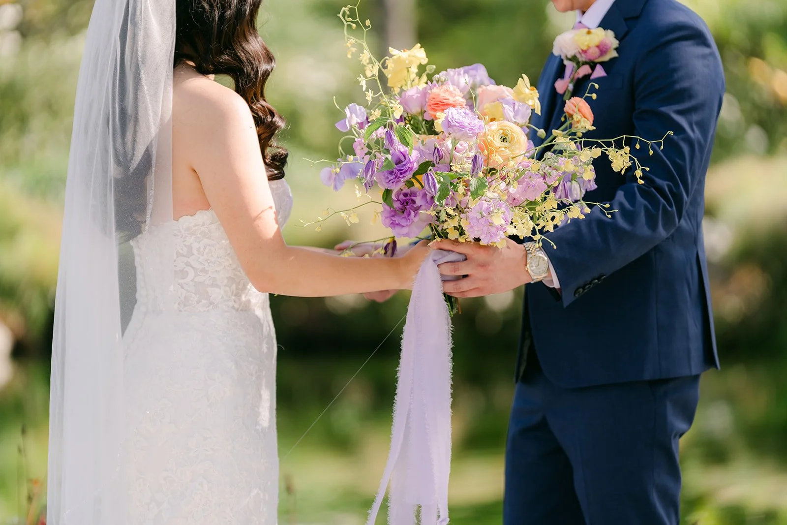Vannie and Elijah together with her bouquet and lilac ribbon.