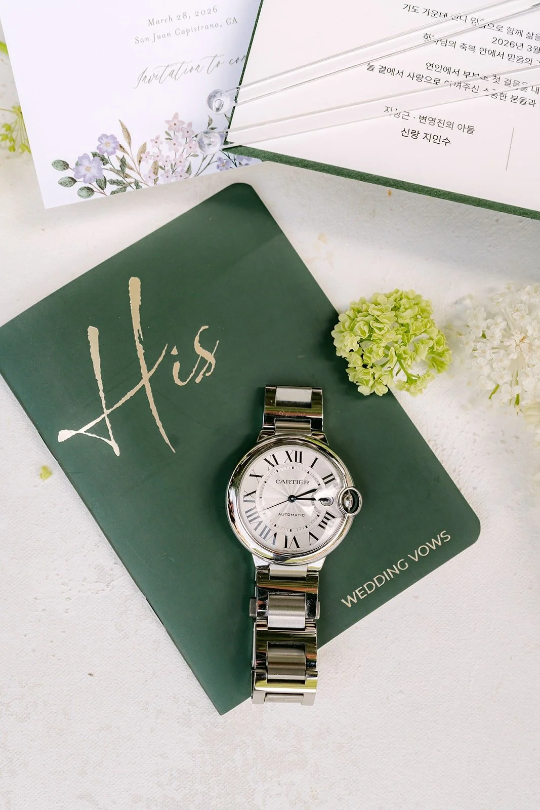 Min Soo's silver watch set on a dark green card