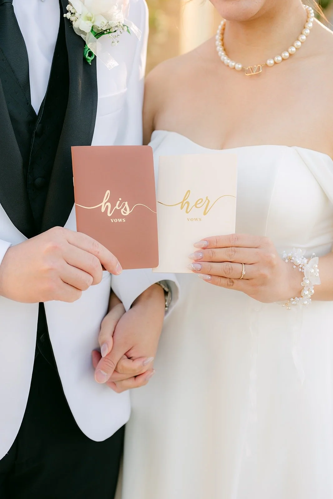 Ivy and Chungman holding their his and hers vow books