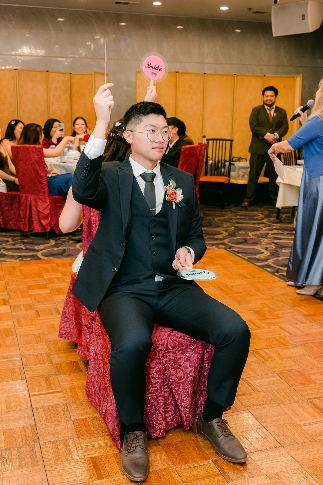Robert holds up a paddle during a reception game