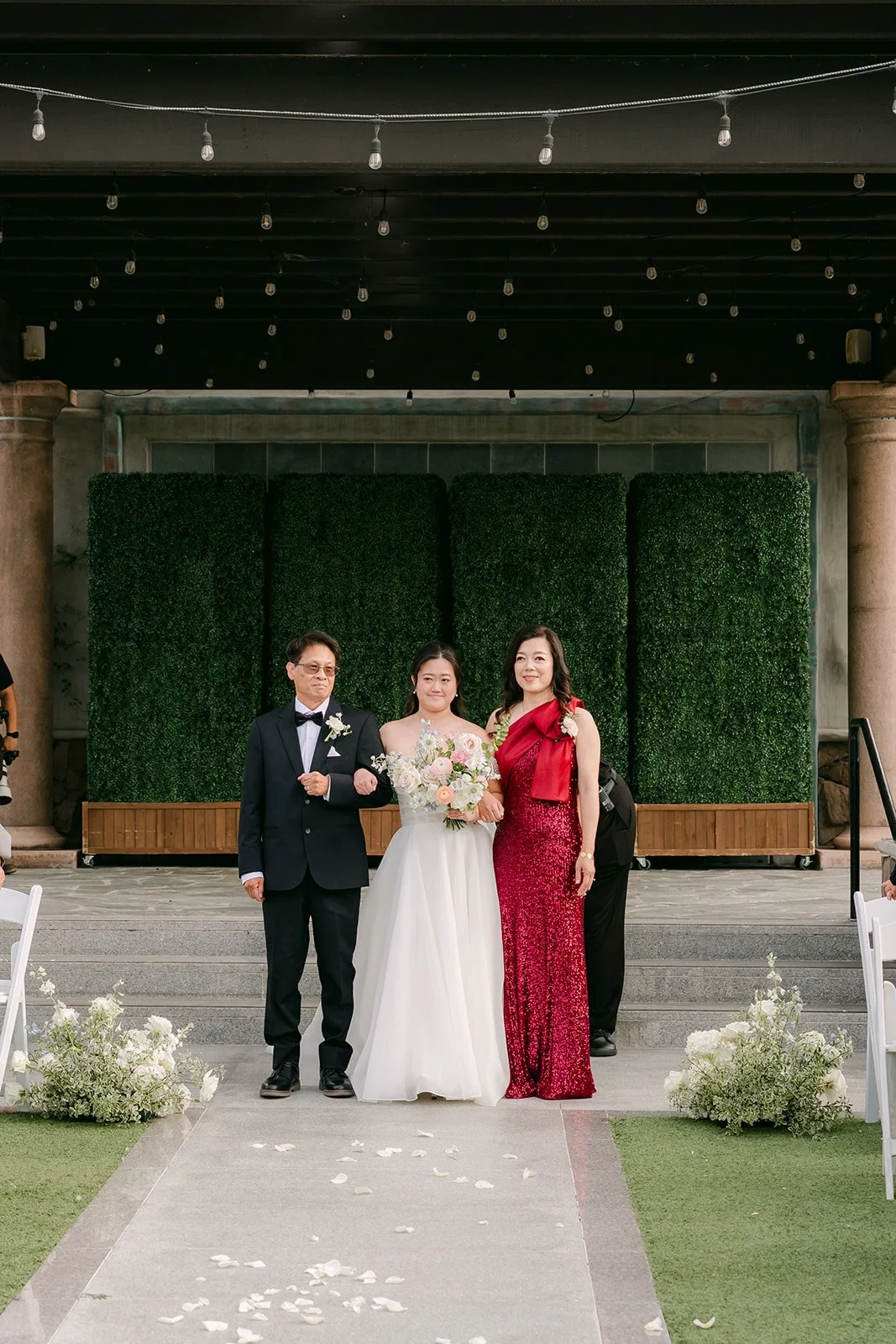 Jessica walking down the aisle with her parents