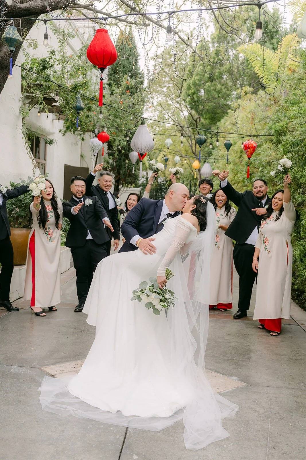 The wedding party celebrating around Vivian and Yao
