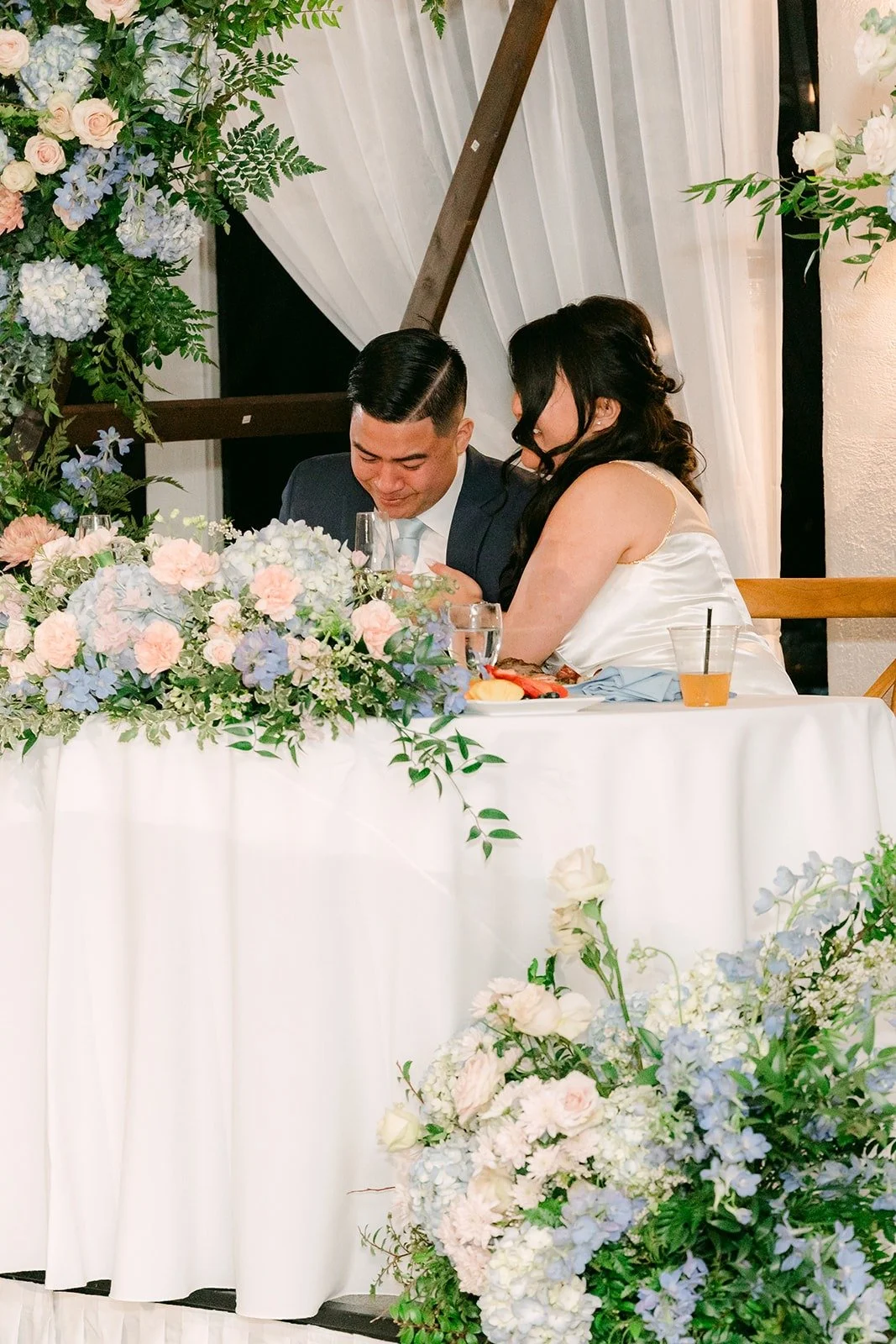 Florence and Jordan listening from the sweetheart table
