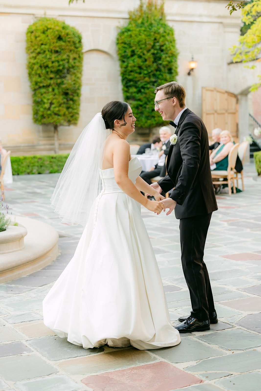Brianna and Nik laughing as guests look on