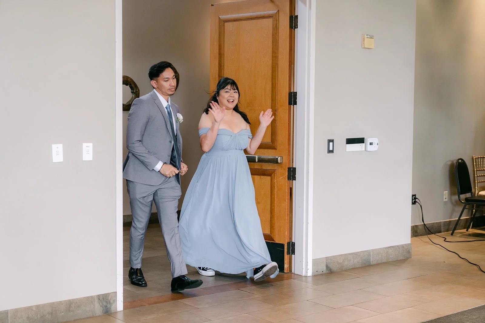 A wedding party pair dancing into the ballroom