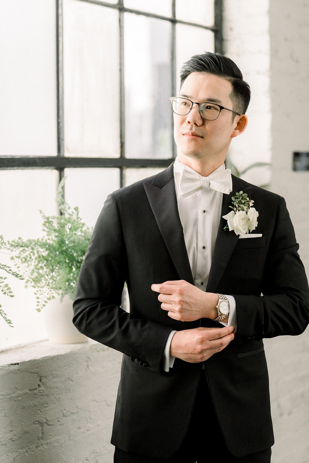 Alex adjusts his cufflinks