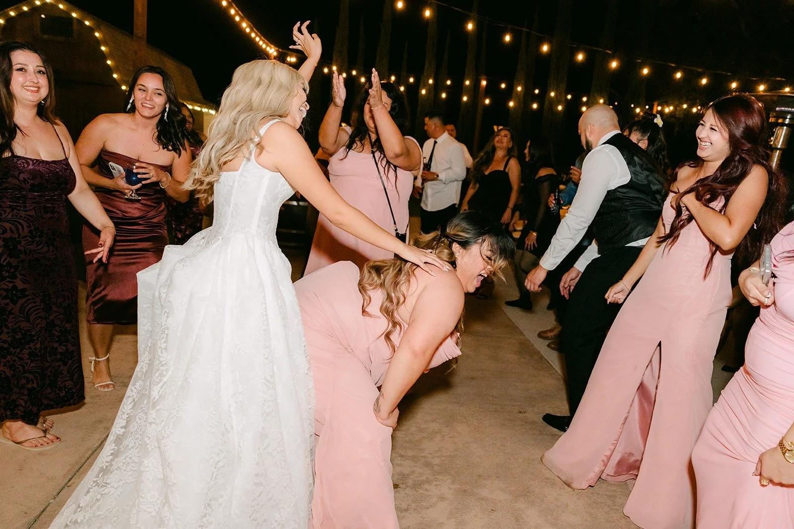 Konitha dancing in her gown with guests all around