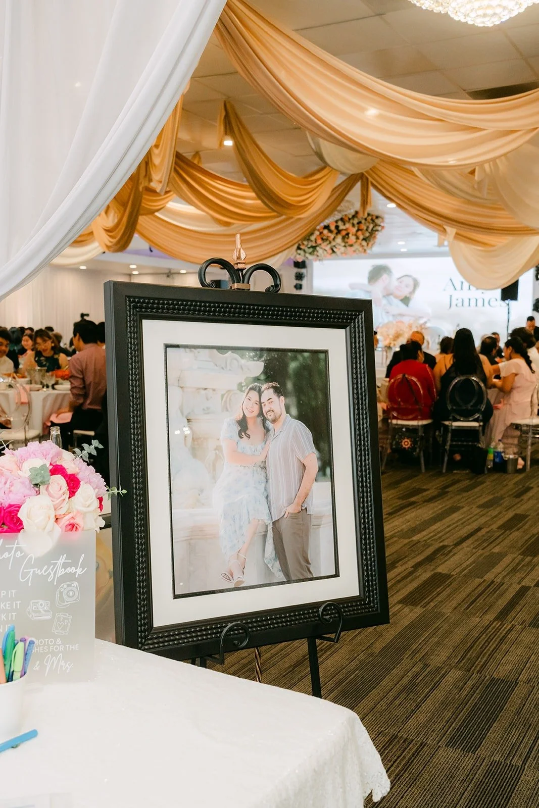 Framed engagement photo of Amy and James at the reception entrance