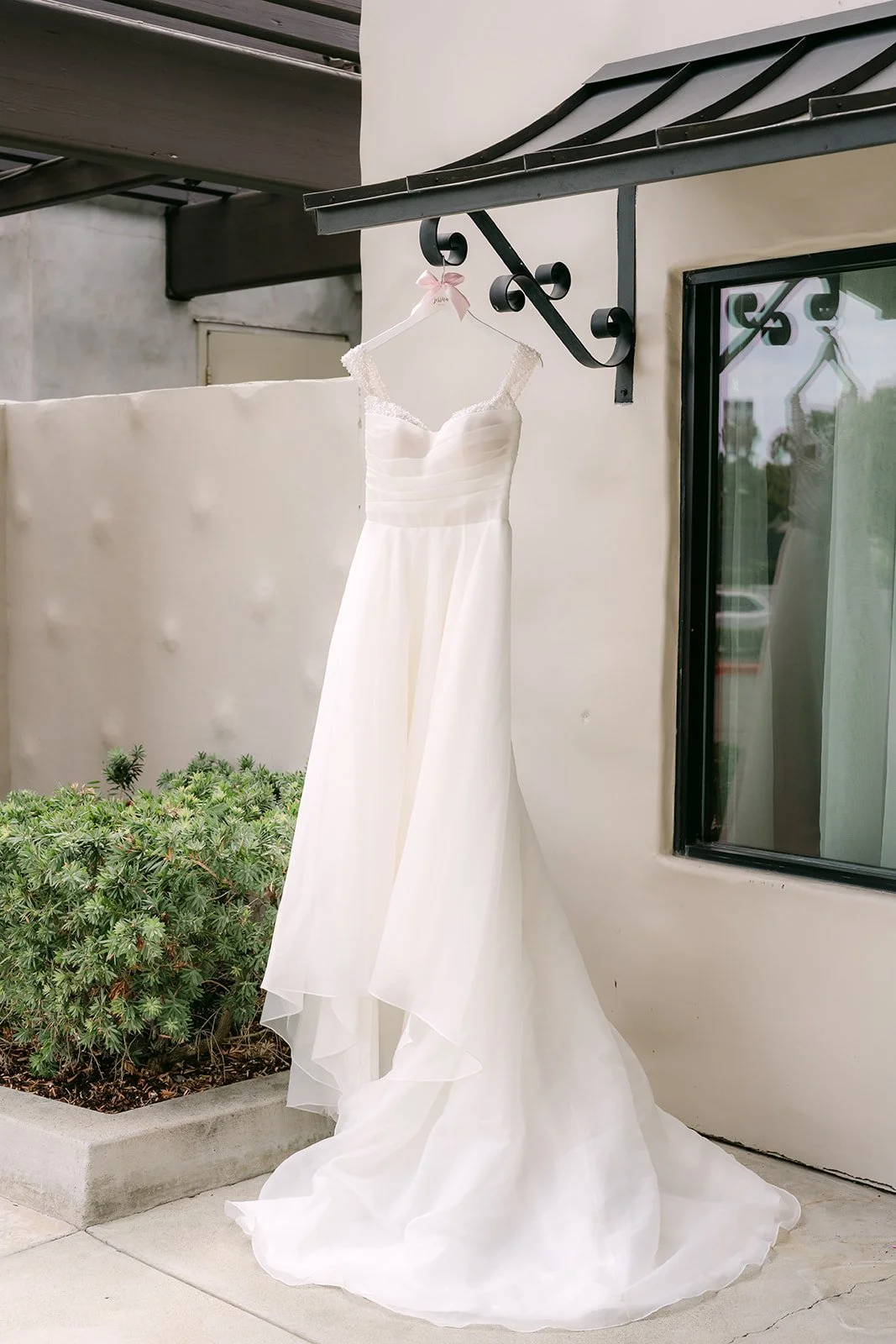 Jessica's wedding gown hanging on the balcony