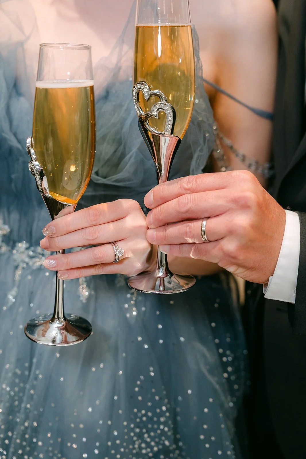 Close up of Eunice and Eric's champagne glasses clinking