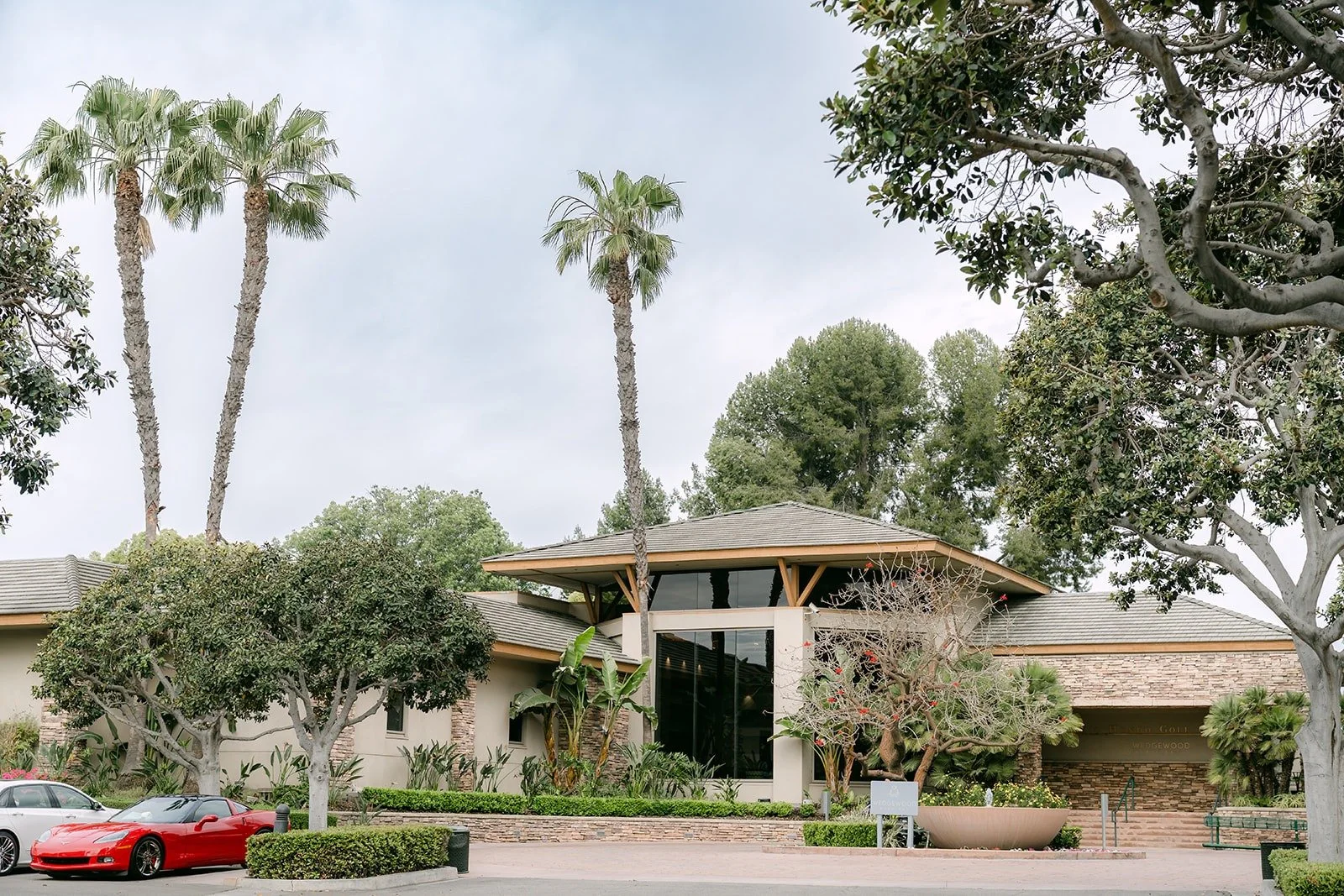 The entrance of Rio Hondo by Wedgewood Weddings in Downey with palm trees and tall pines