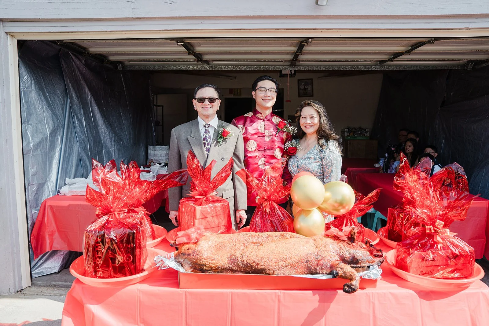 Gift trays and roast pigs laid out in the garage.