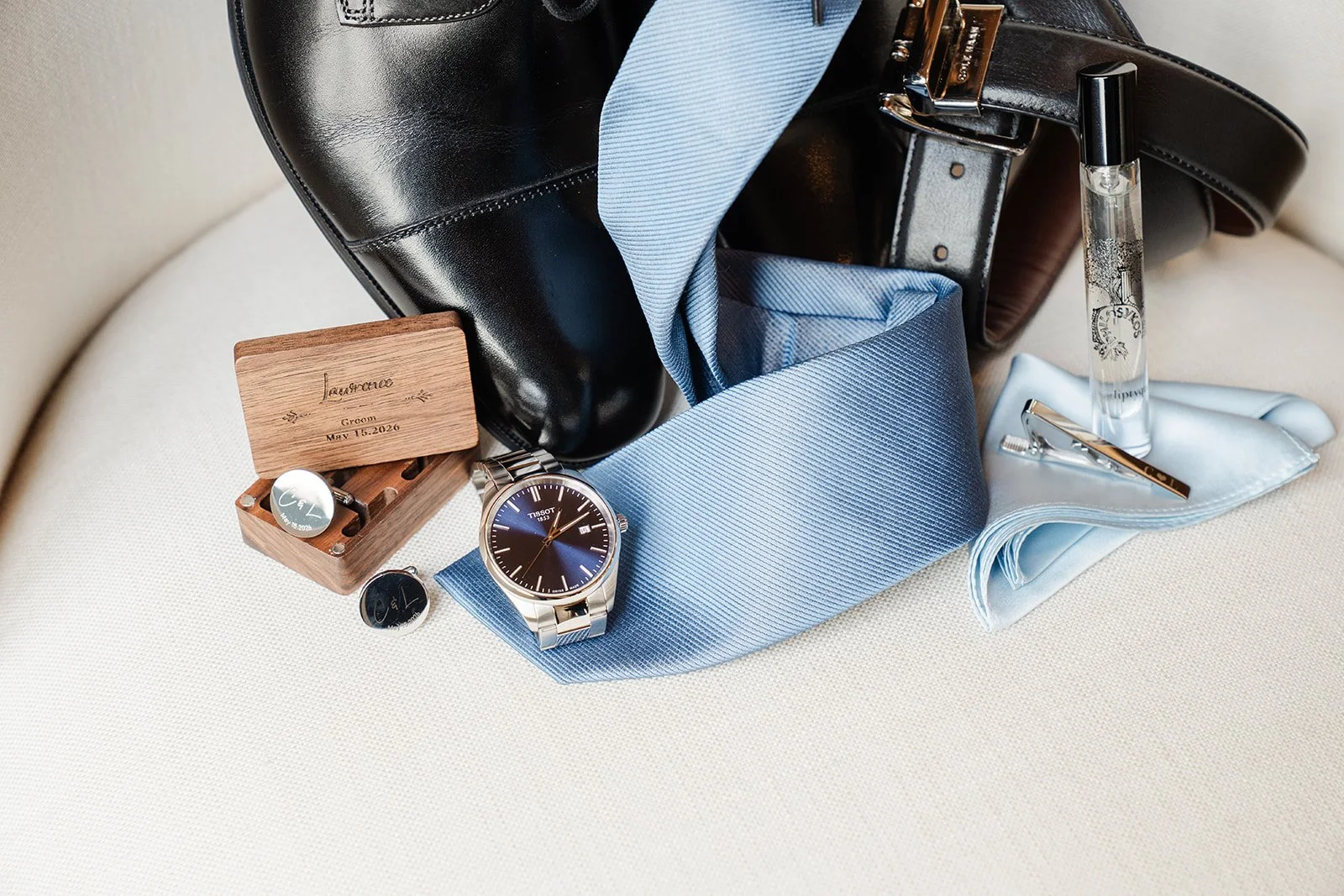 Groom's details with black shoes, light blue tie and watch