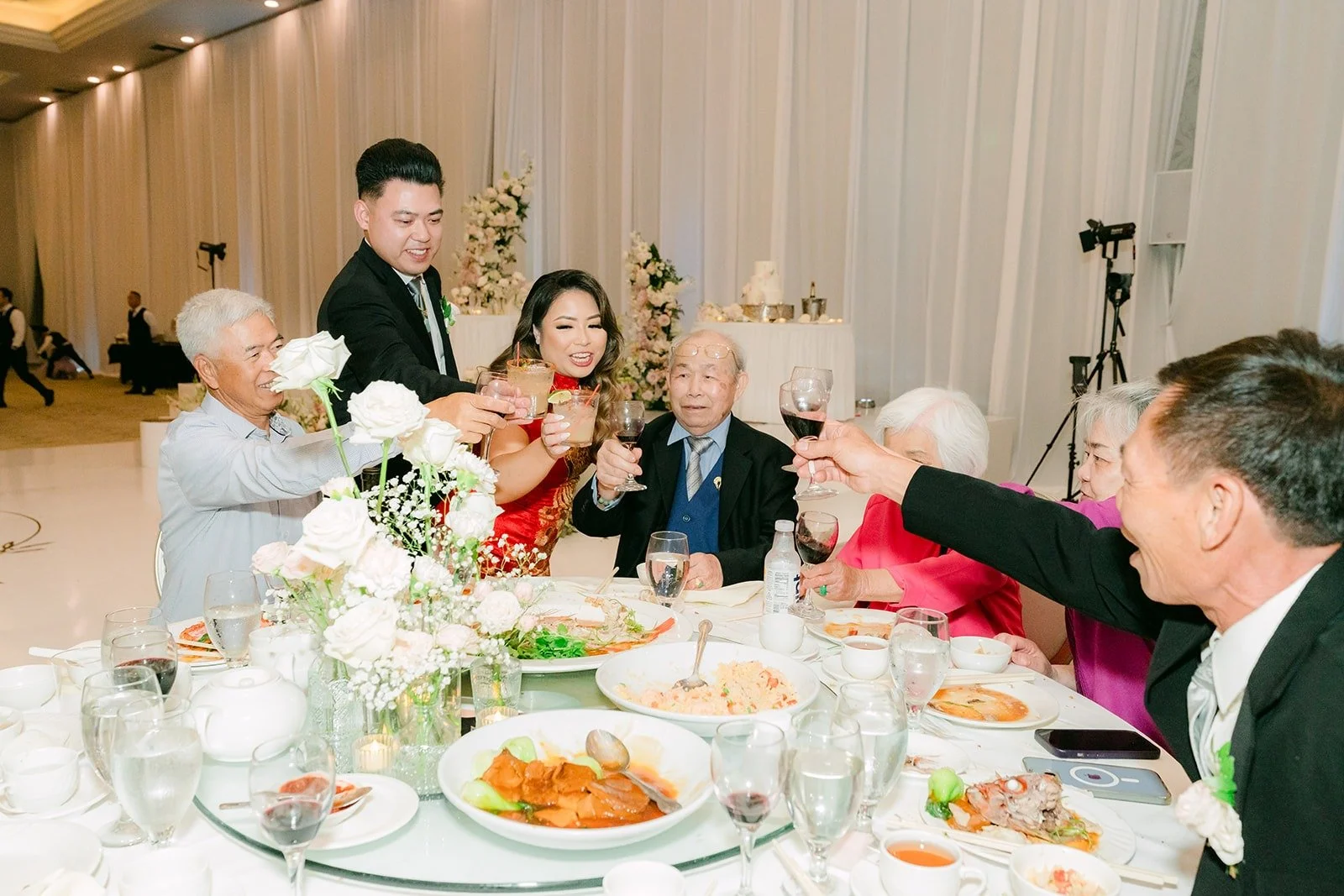 Guests raising their glasses during table visits