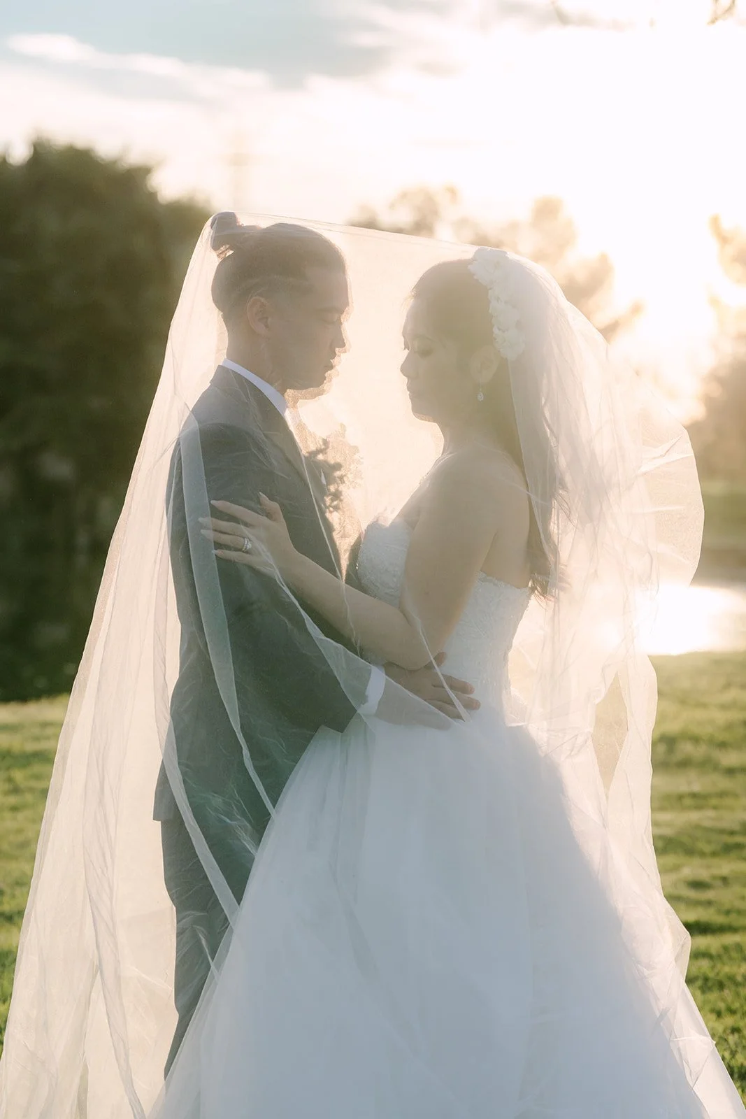 Kate and Michael embracing as the sun sets behind them.