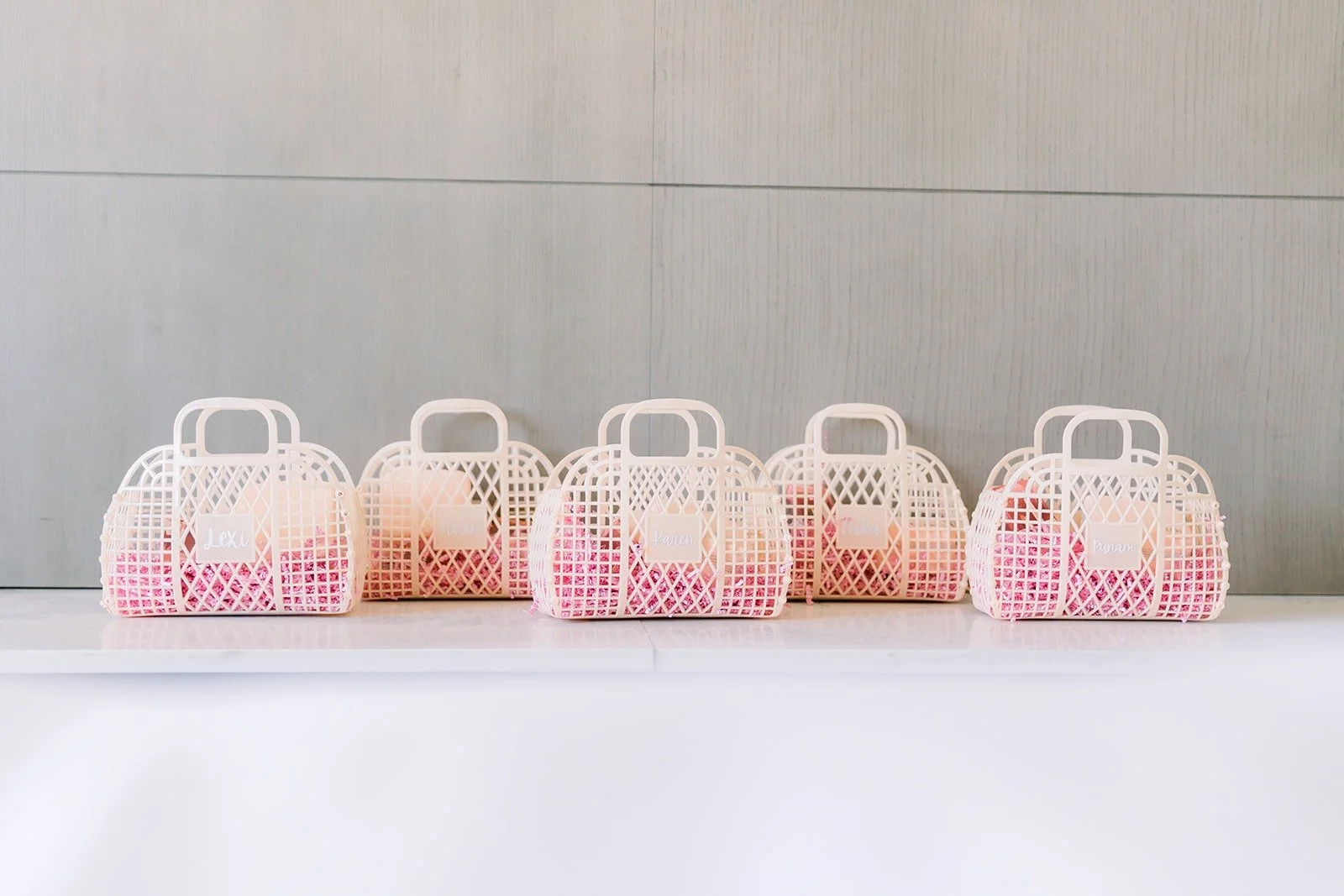 Pink gift bags lined up for the bridesmaids