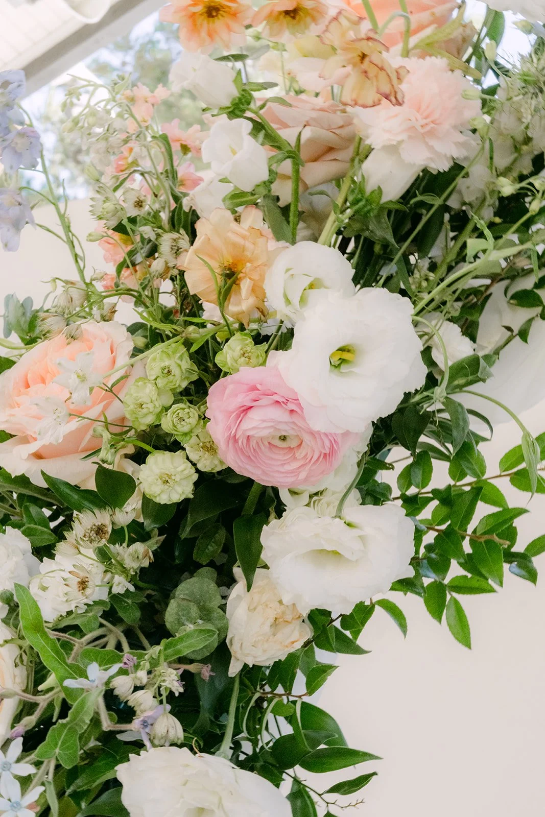 Close up of the white and blush ceremony florals