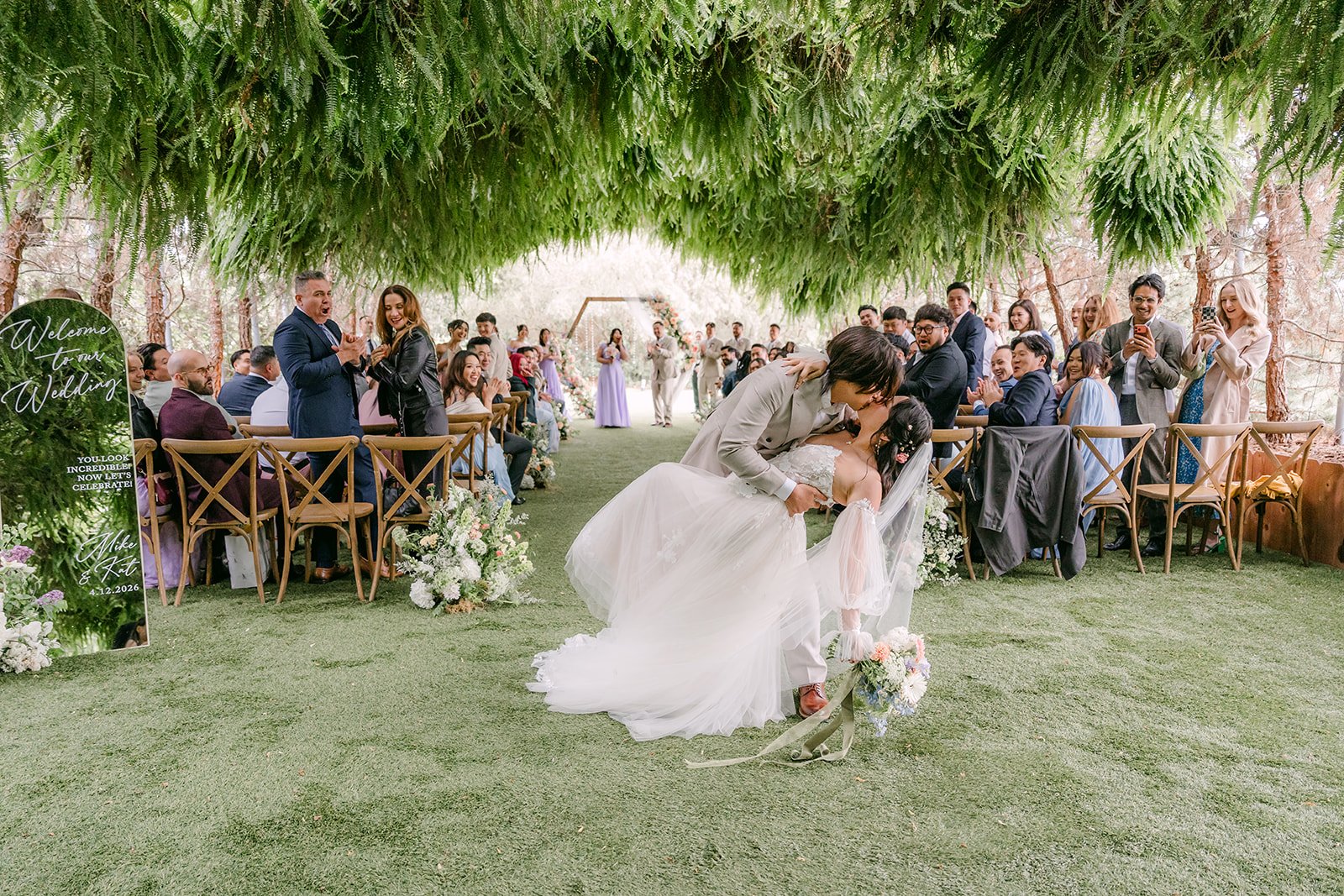 Mike dipping Kat for a kiss in the middle of the grotto aisle