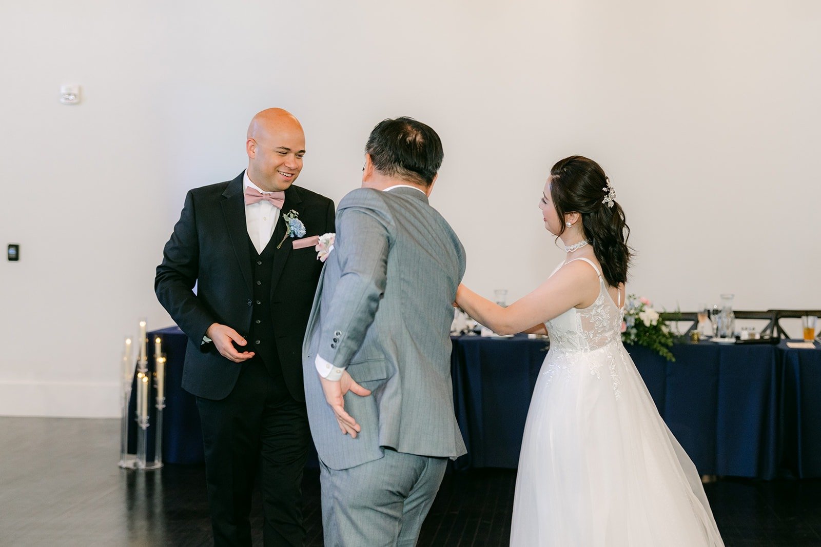 Elisa takes a family member's hand to begin the father daughter dance