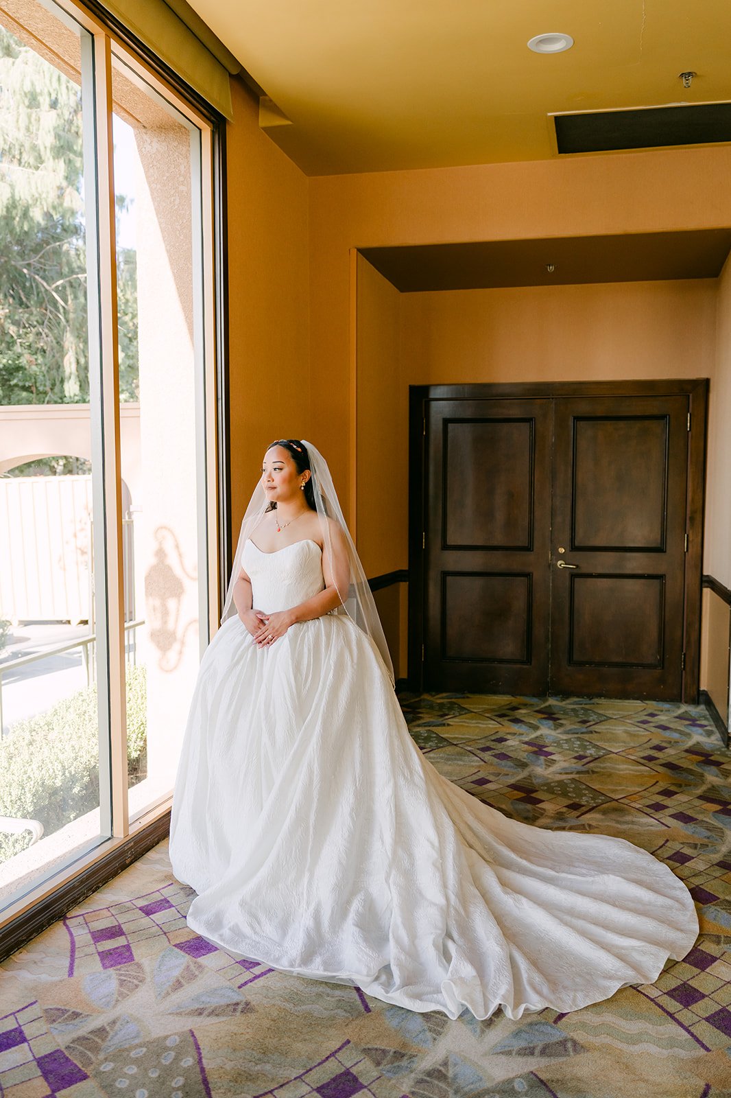 Angela in her gown by the window at Almansor Court