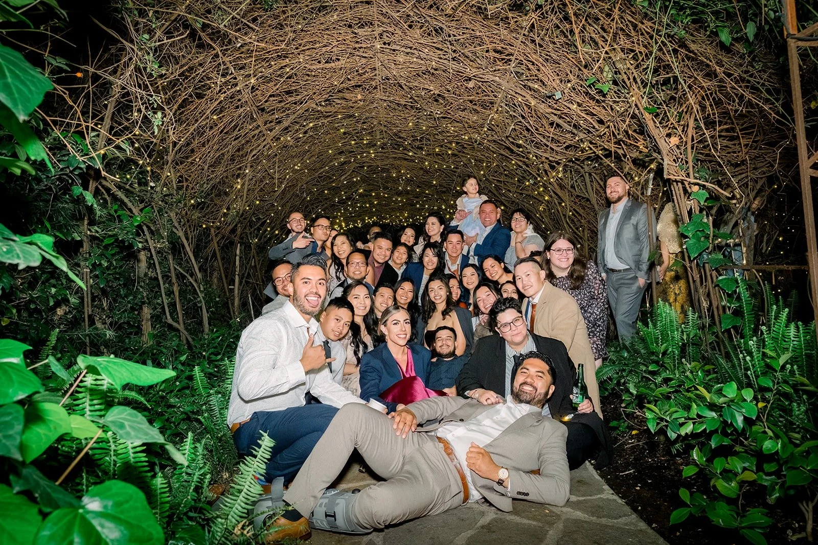 Hannah and Vincent with their friends in the twinkling tunnel, photographed by One and Only Production