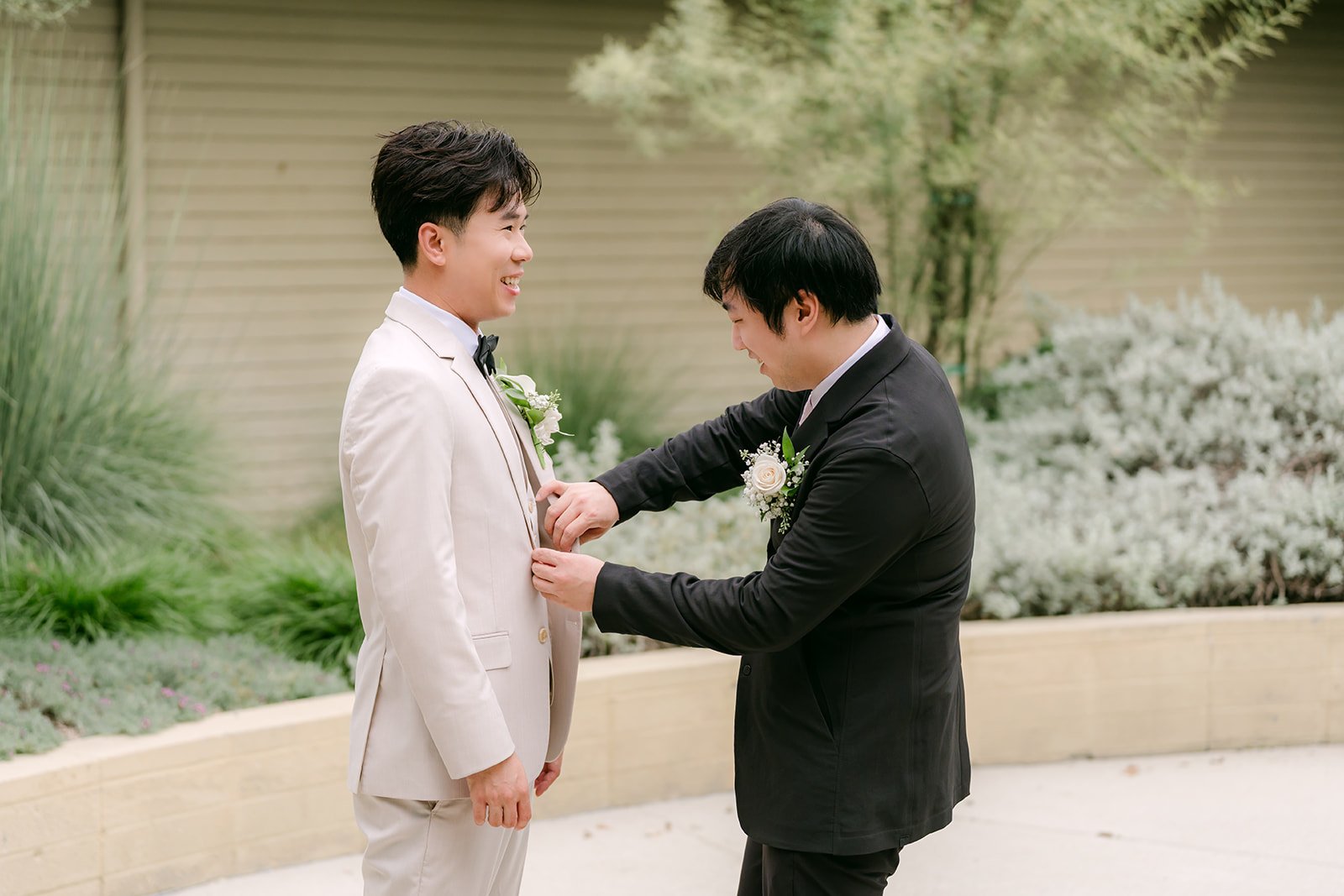 Henry fixing Wen's boutonniere.