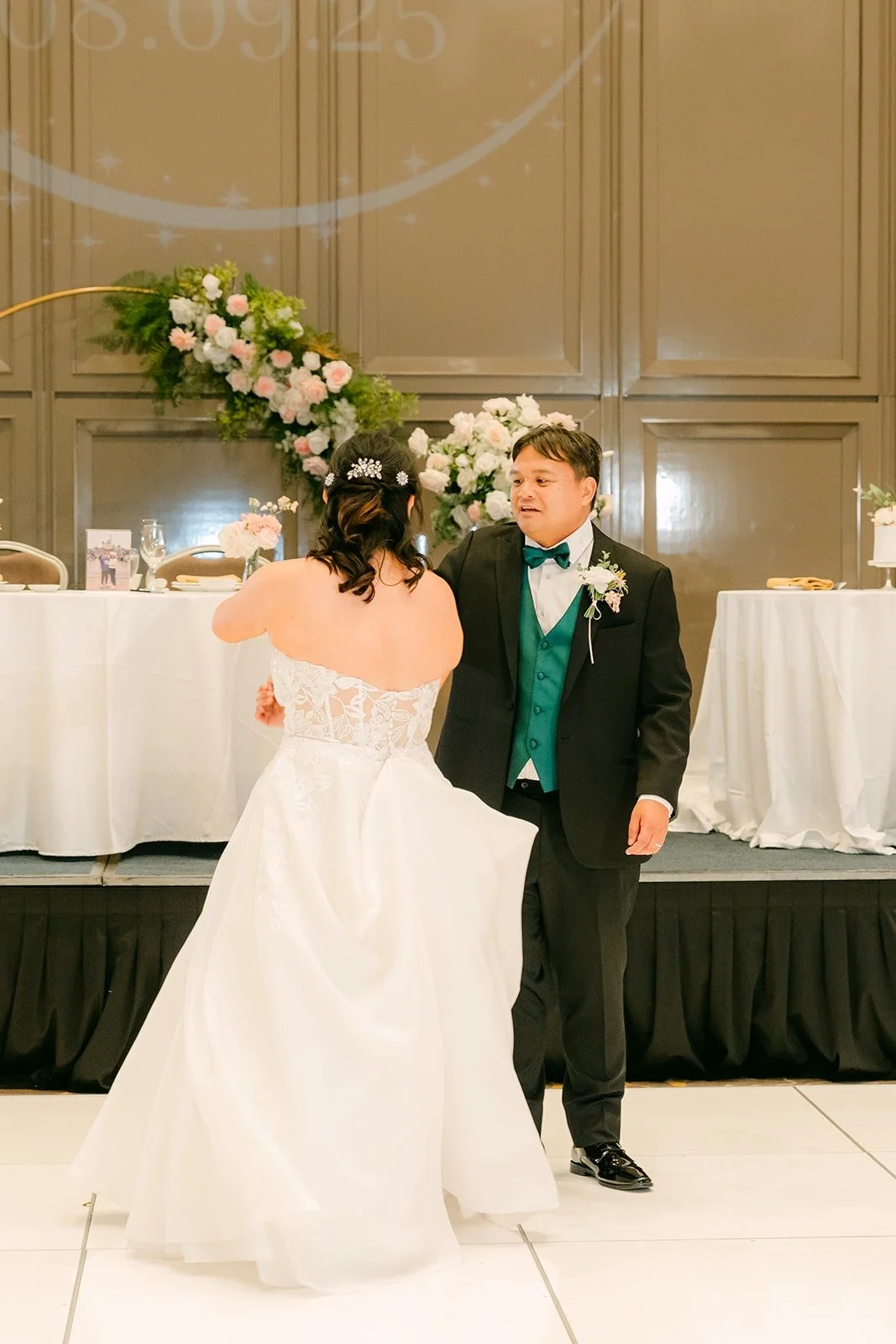 Stella and James beginning their first dance on the white dance floor