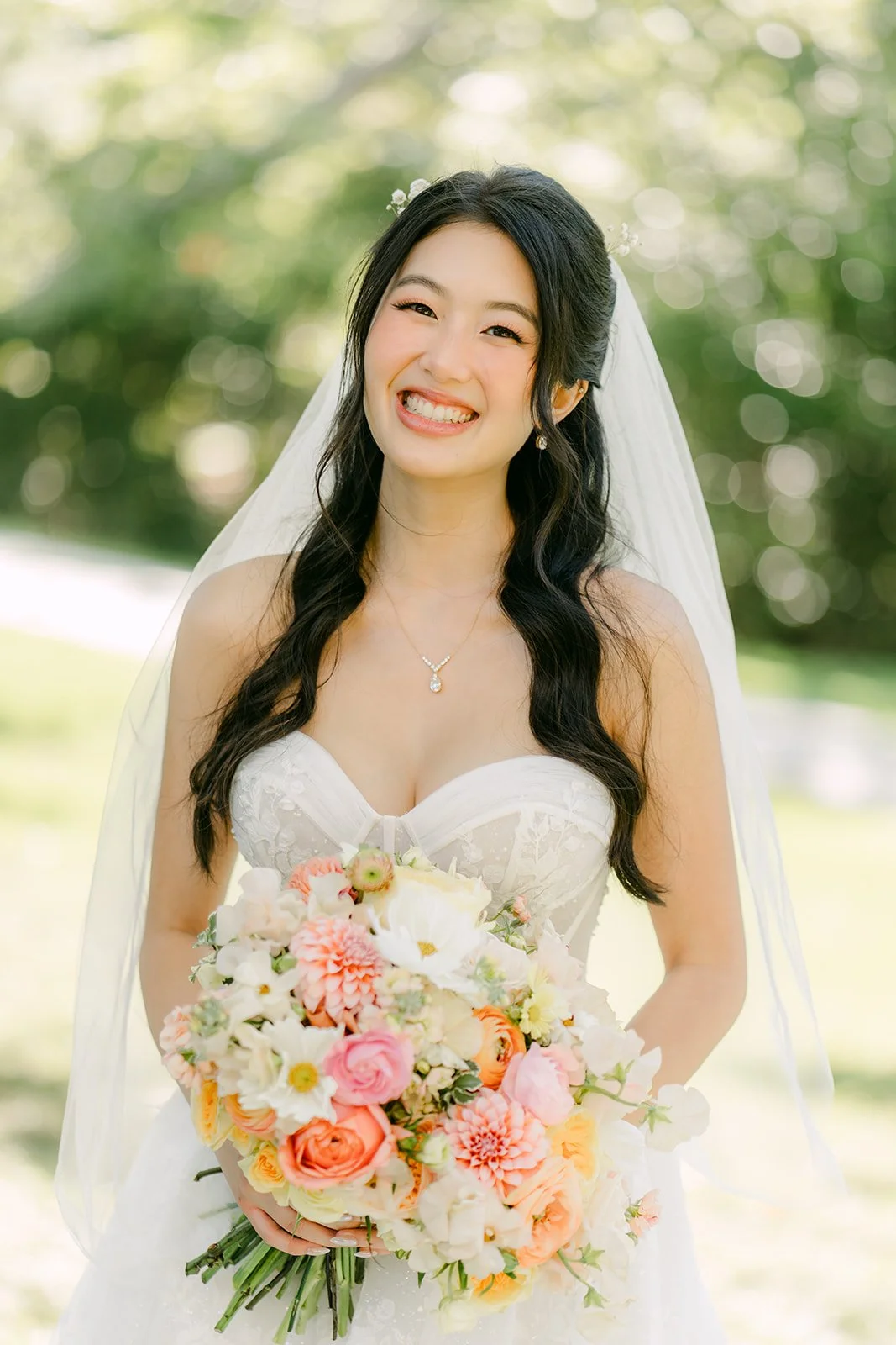 Clarissa smiling with her bouquet in the park
