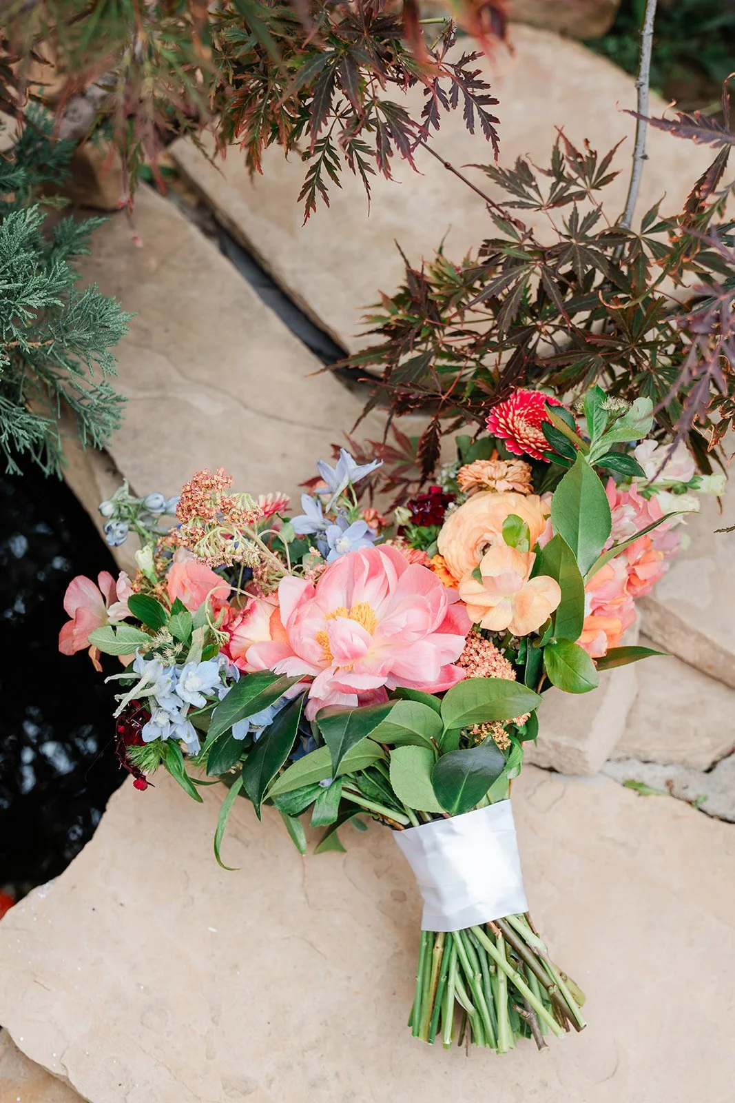 Bridgette's bouquet of peach, pink and blue blooms.