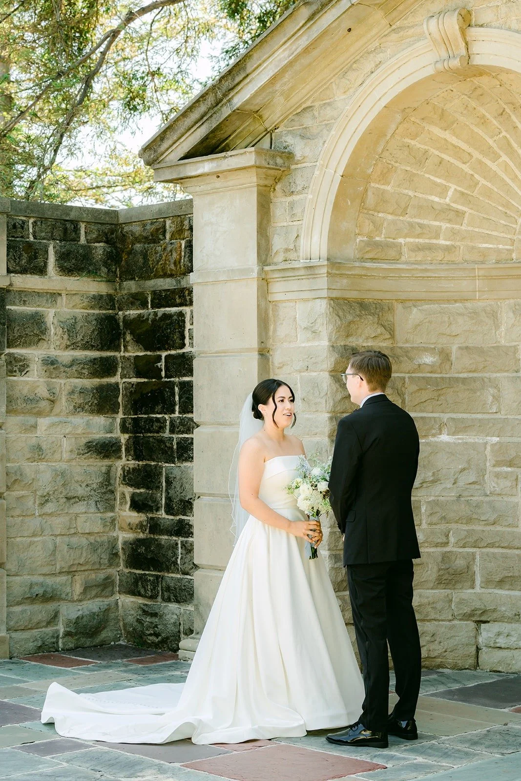 Brianna and Nik facing each other at the carved stone niche