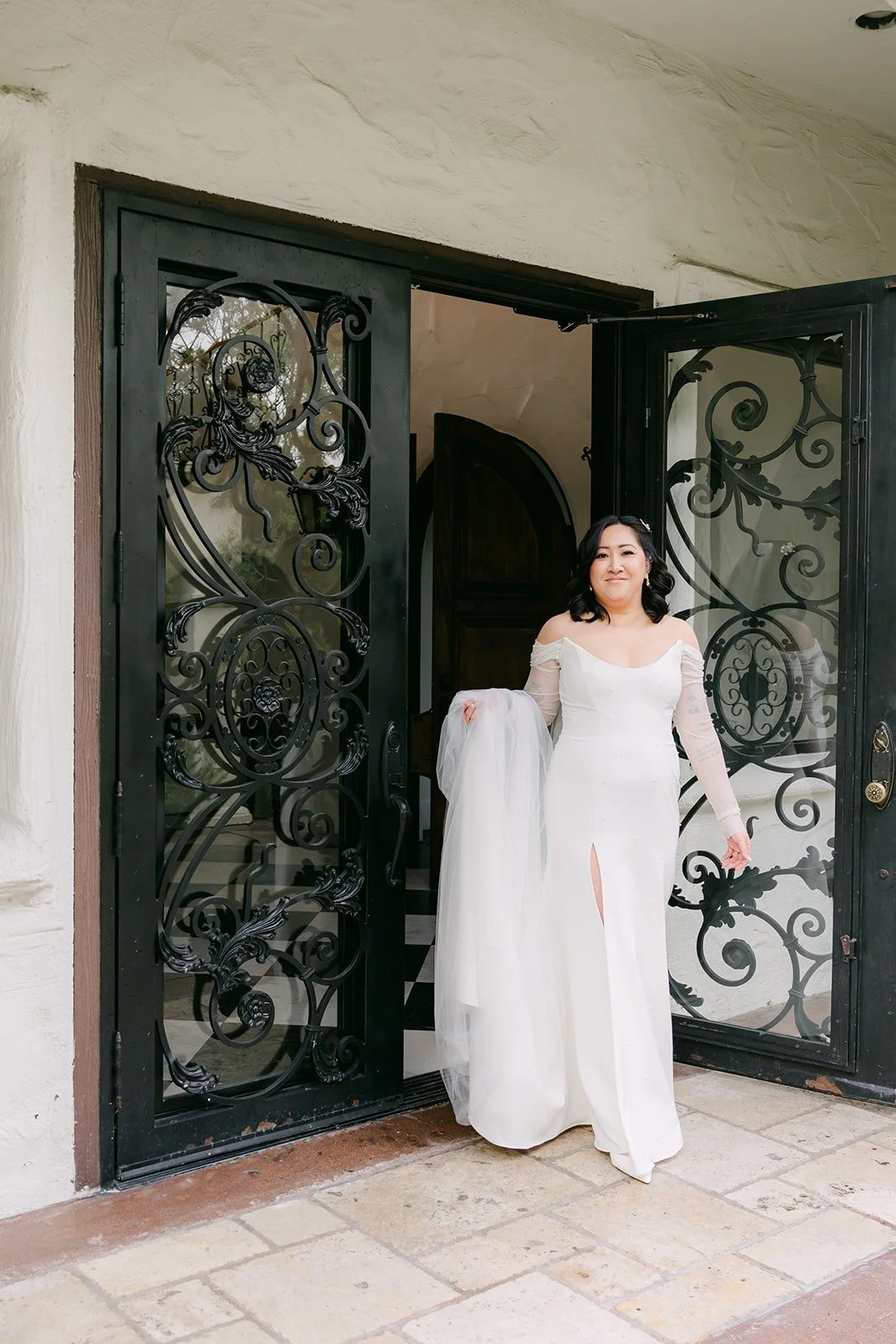 Vivian stepping through the iron doors for the first look