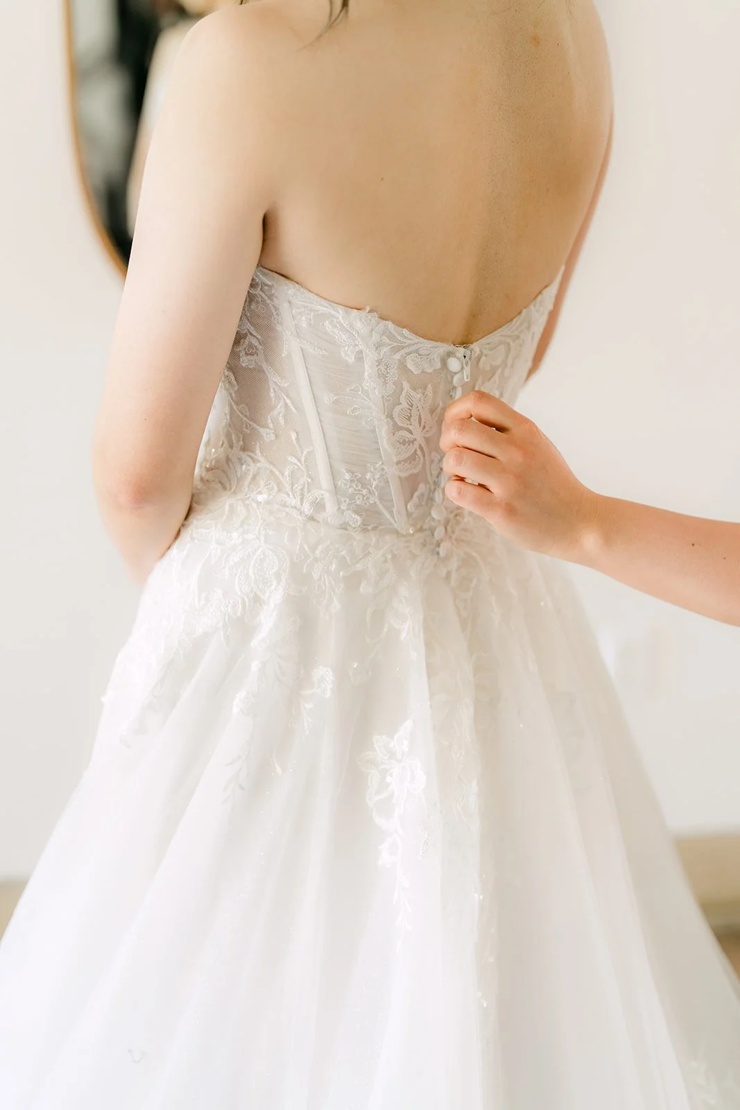 Close-up of the lace-up back of the bride's wedding gown