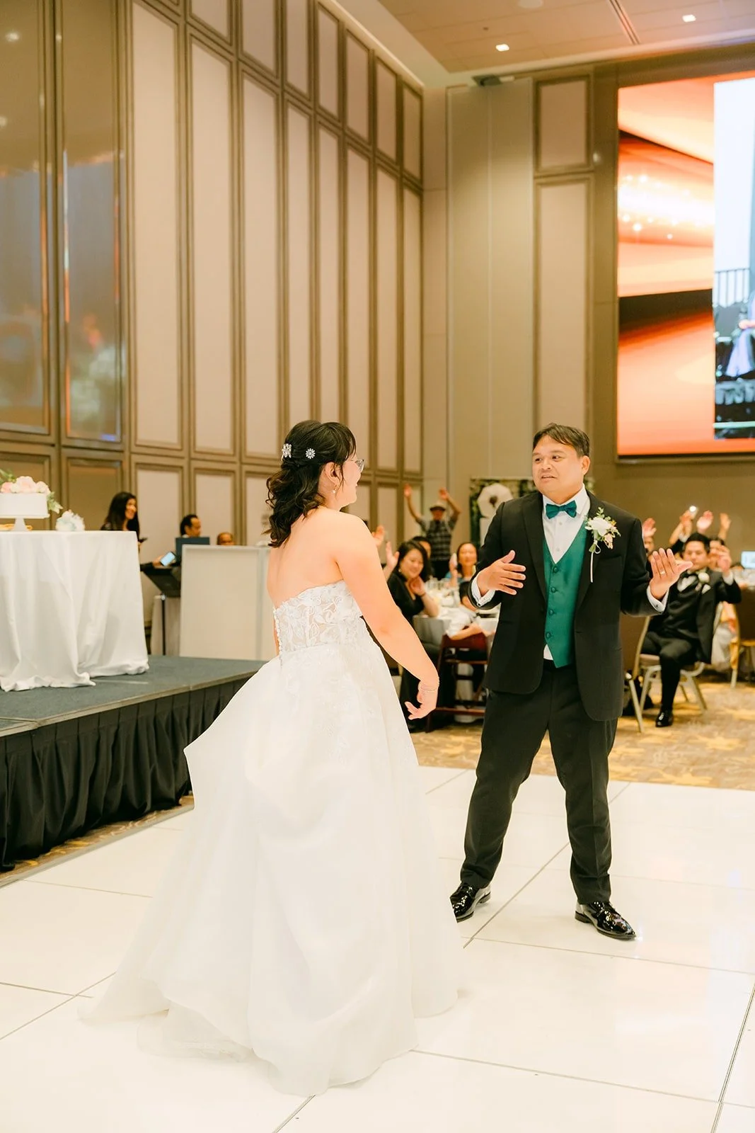 James twirling Stella across the dance floor during their first dance