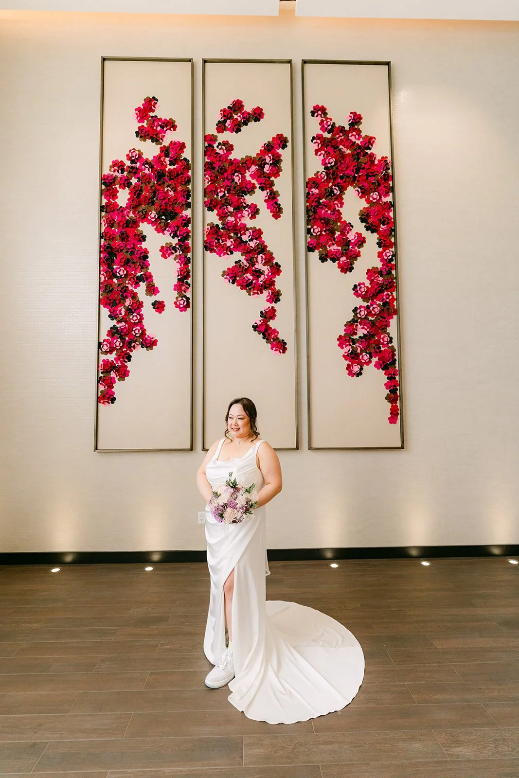 Mai in front of the red floral wall at the Sheraton.