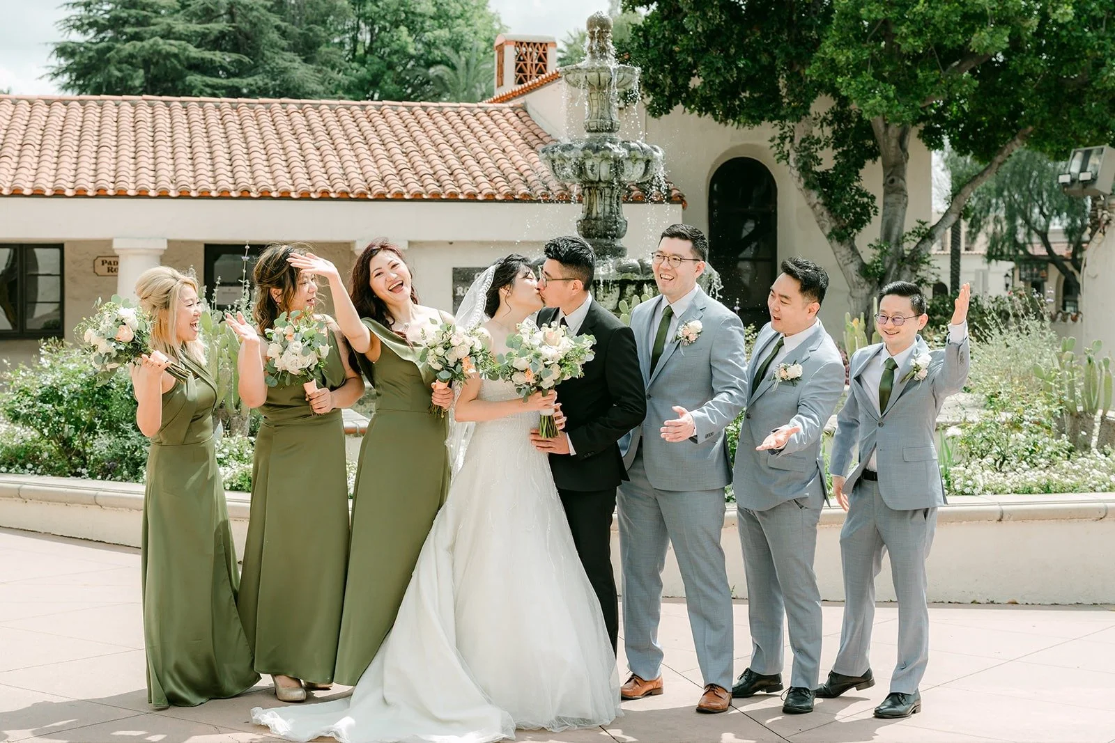 The full wedding party lined up at the San Gabriel Mission fountain