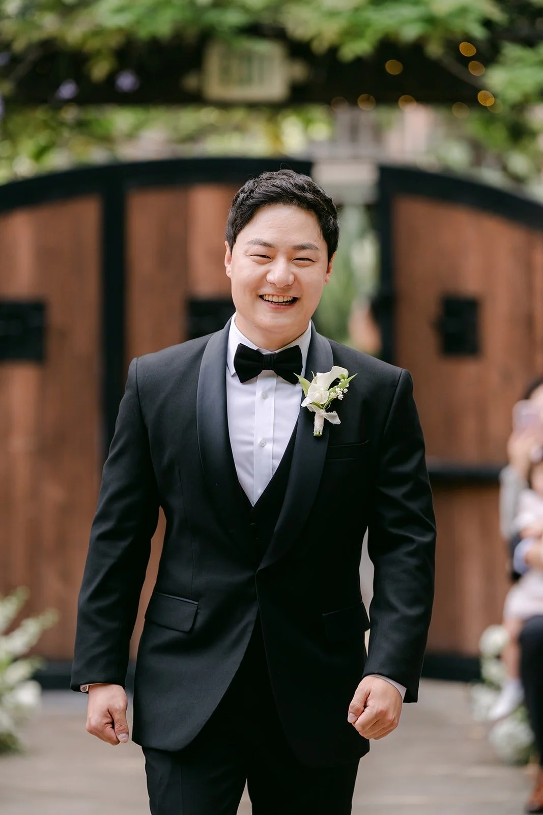 Min Soo smiling as he walks in through the wooden doors