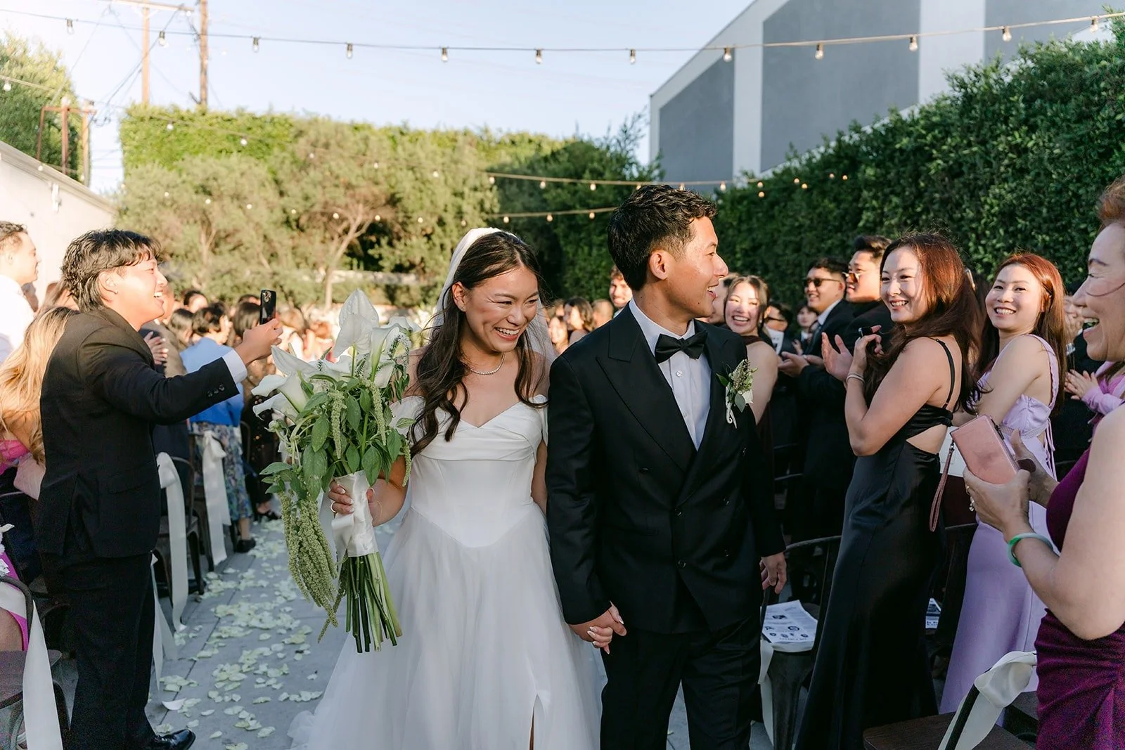 Jadee and Richard walking back up the aisle as husband and wife, photographed by One and Only Production