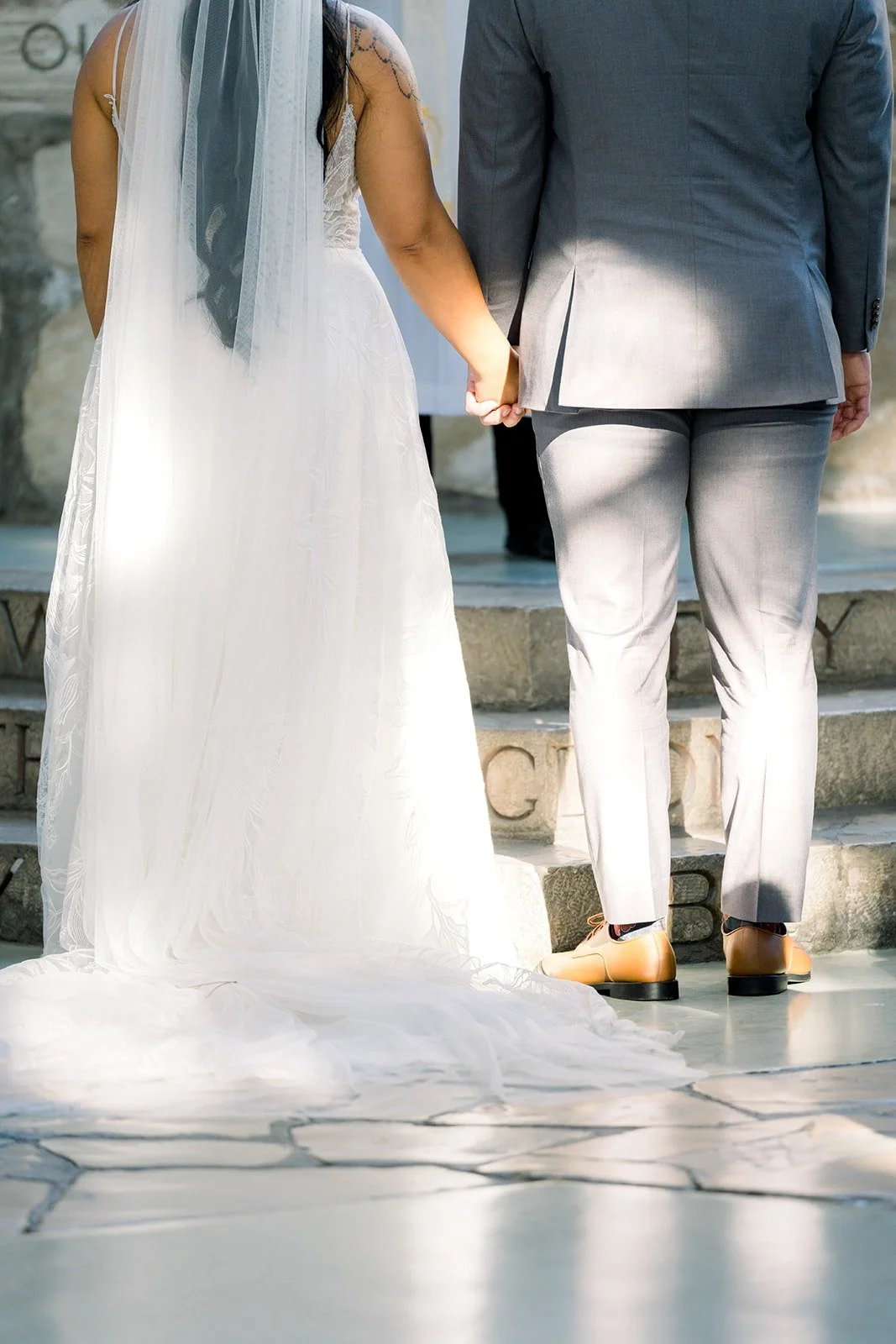 Betsy and Mikey hold hands at the altar steps