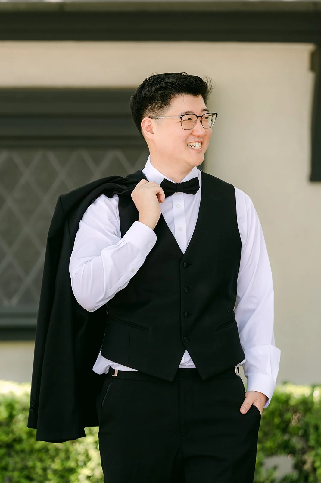 Joshua putting on his tuxedo jacket
