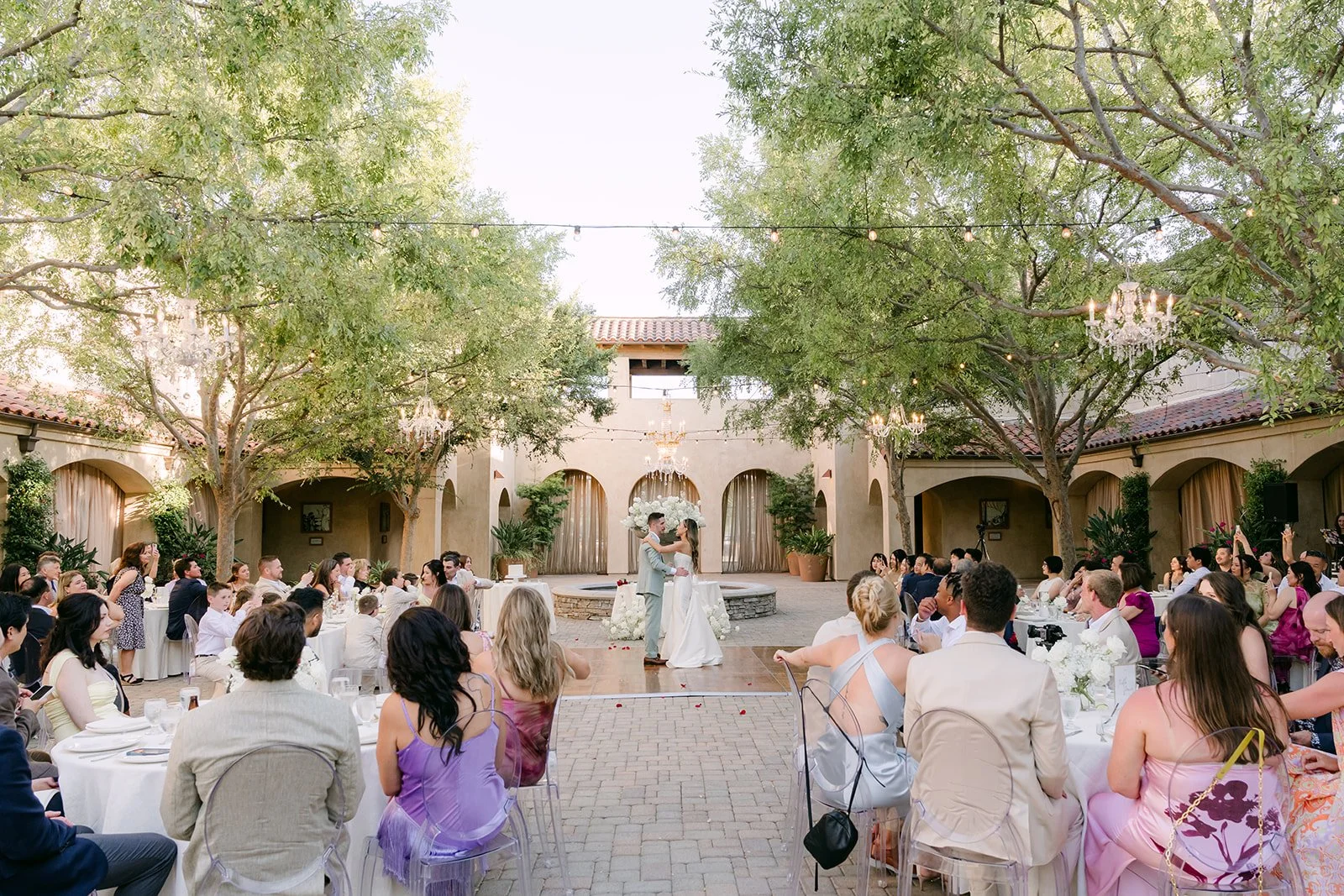 Guests watching the first dance in the Serra Plaza courtyard