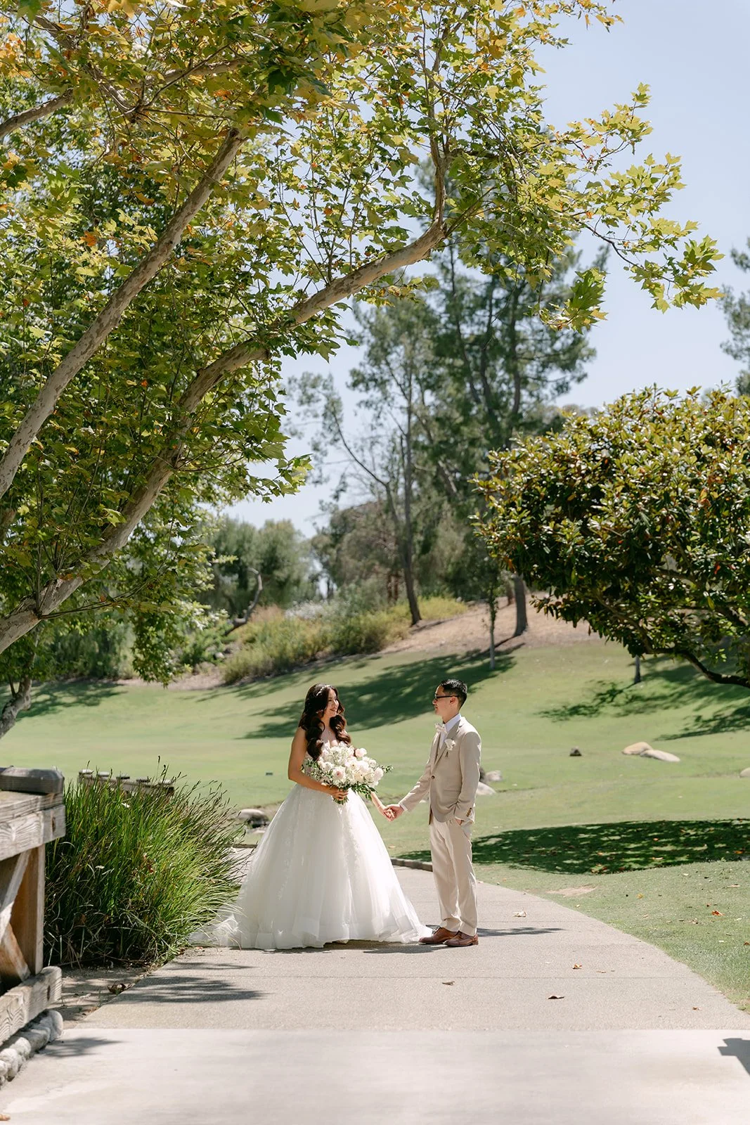 Sandra and Kevin walking down a sunny path at Coyote Hills Golf Course.