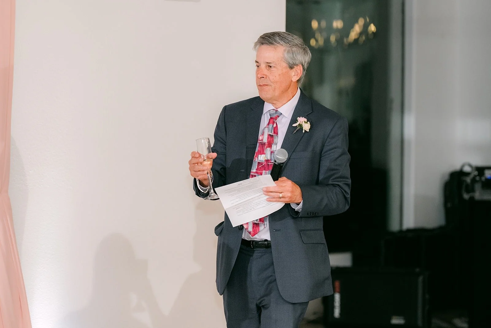 A guest giving a speech with notes in hand