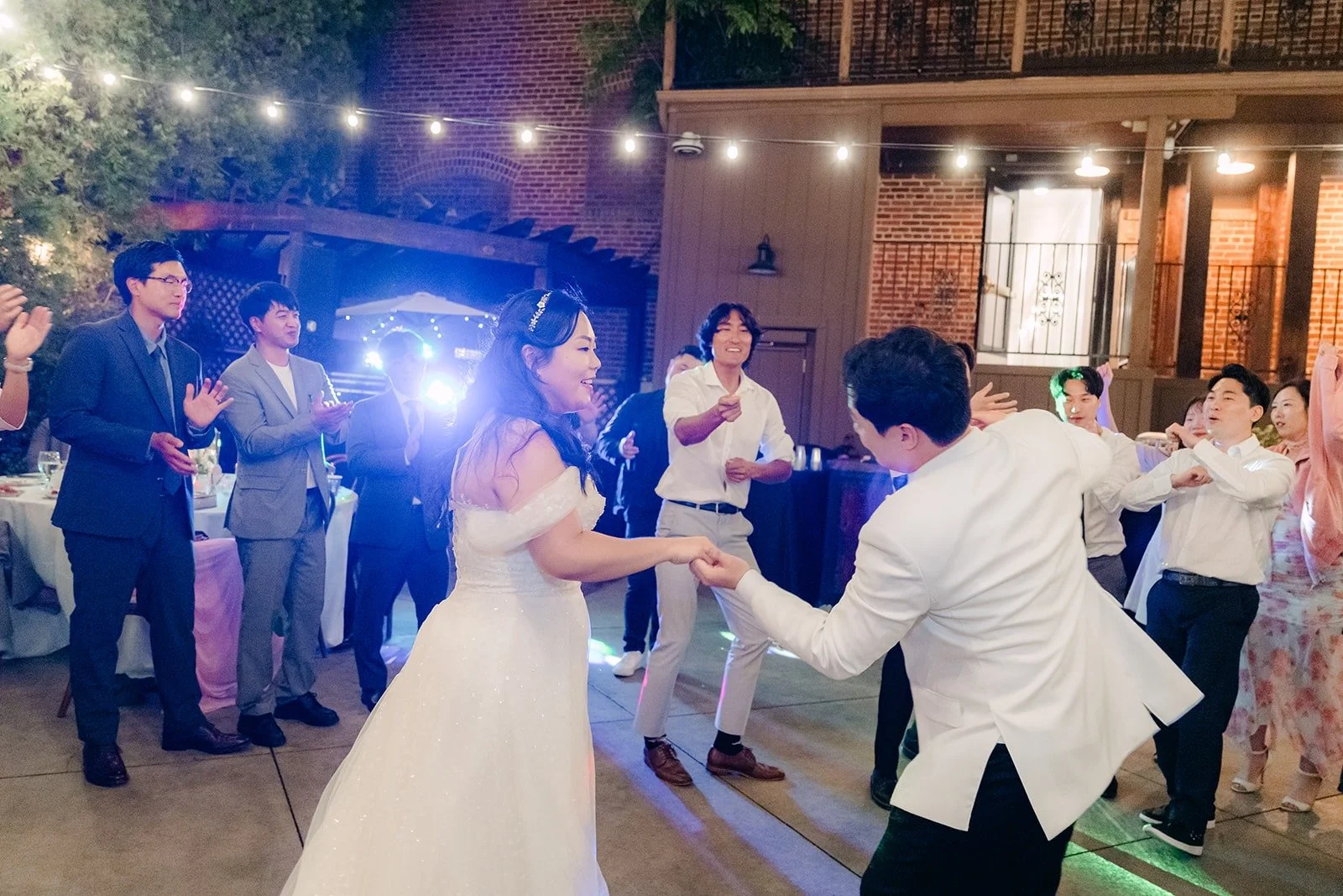 Guests dancing under colored lights
