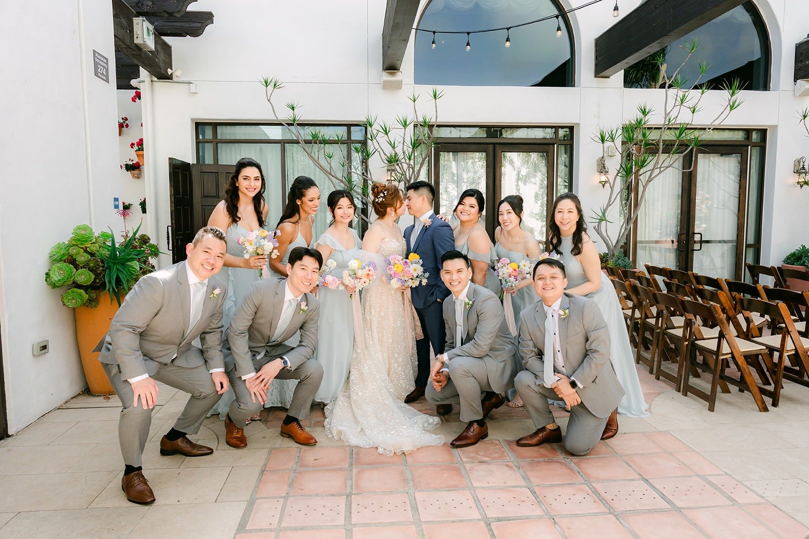 The wedding party seated together in the courtyard